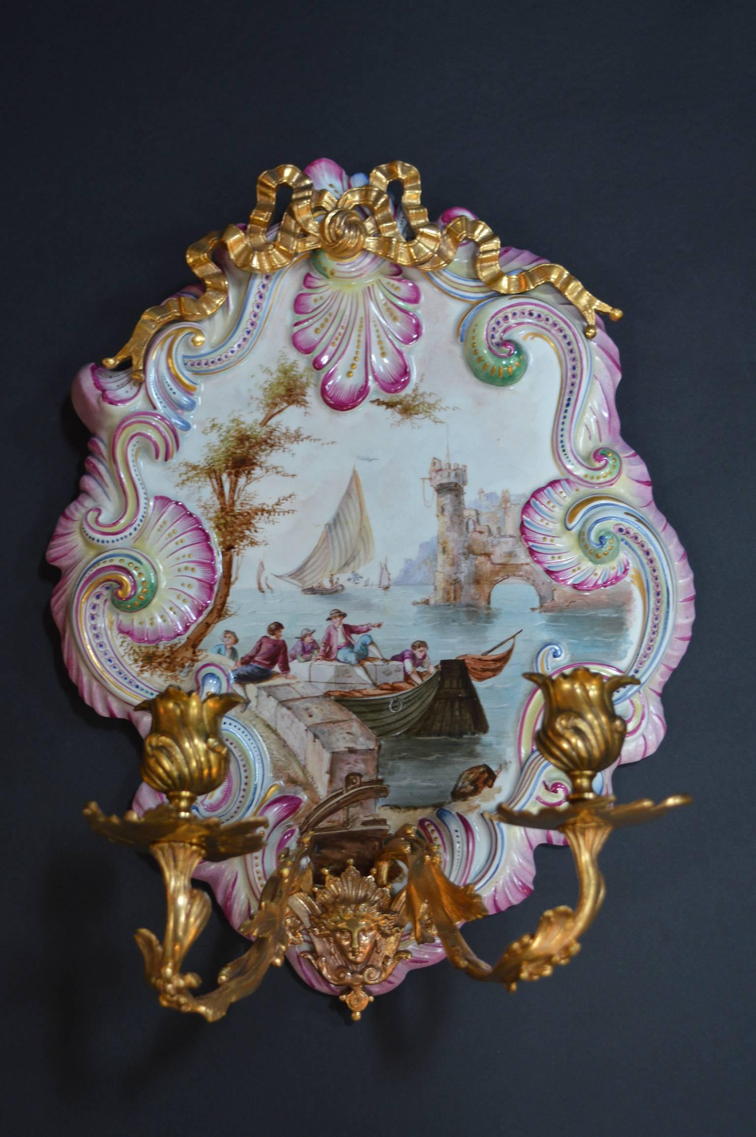 Pair of French faience wall sconces, with ormolu-mounted candle arms.