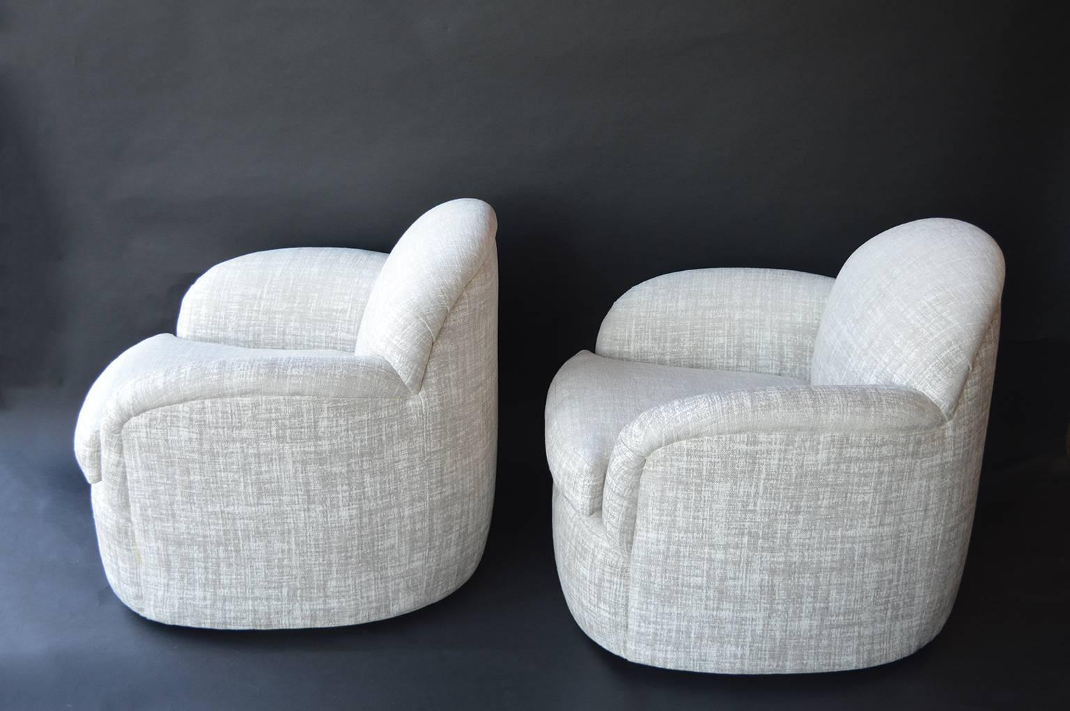 Pair of Milo Baughman swivel armchairs with a luxe pearl fabric.