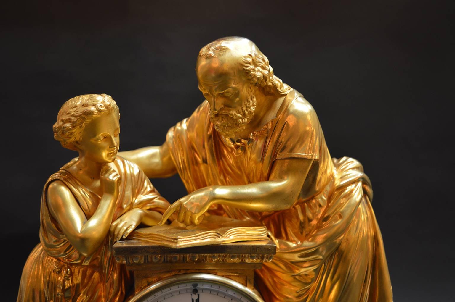 French doré bronze and white marble clock with figures of a scholar with a young student.