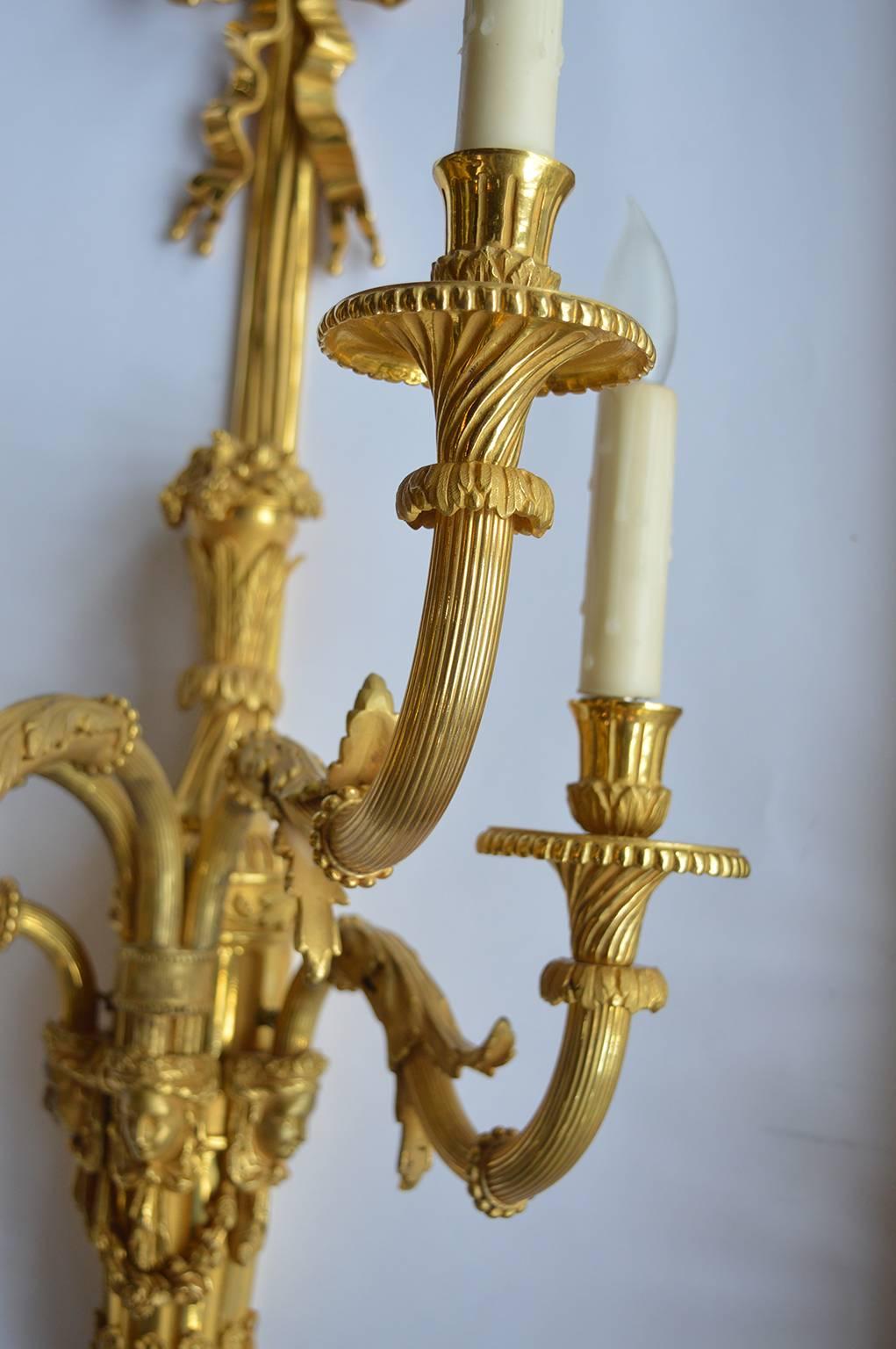 Four oversized gilt bronze, French sconces with beautiful detailing.