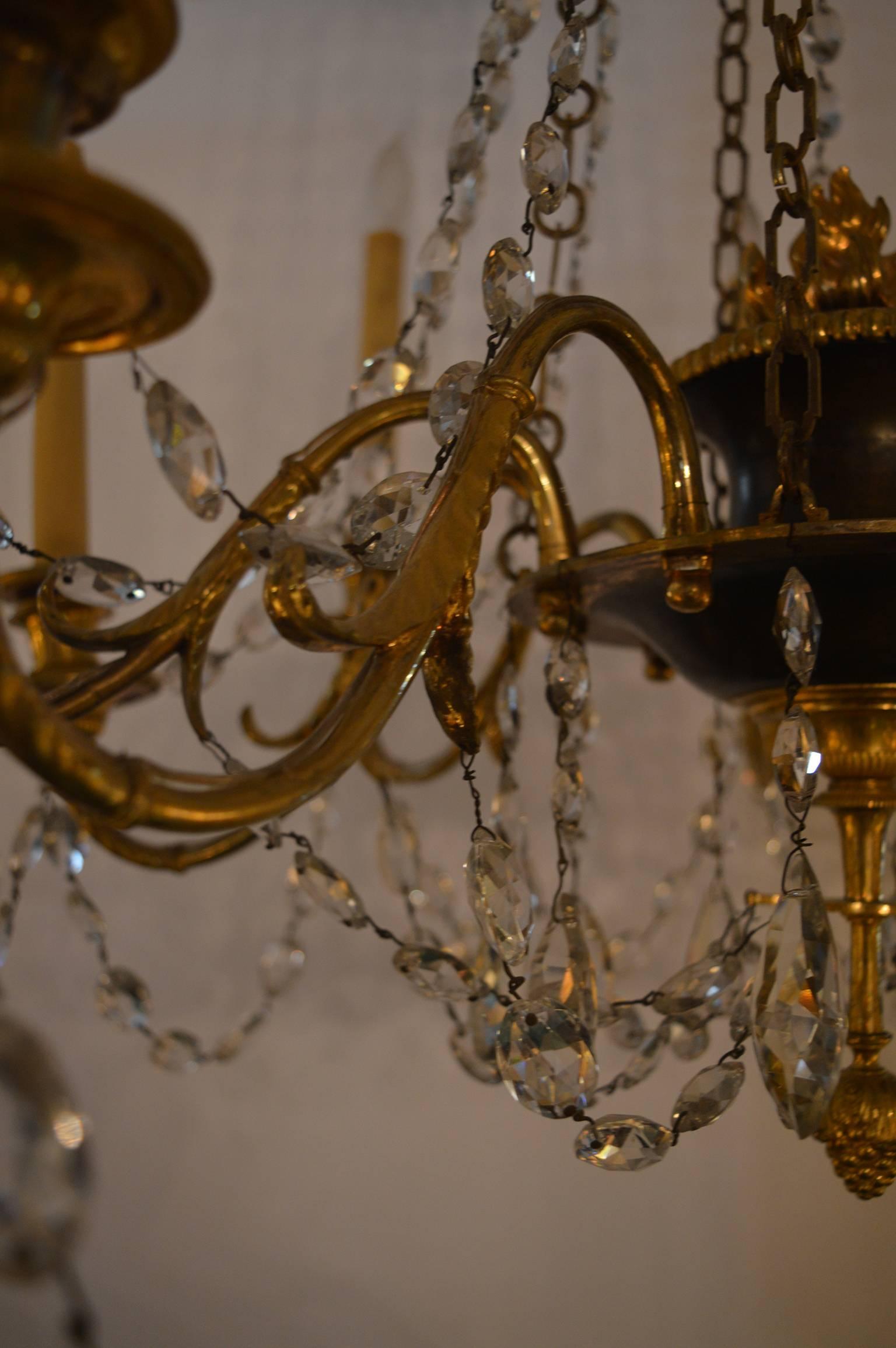 Gilt bronze chandelier with crystal adornments.