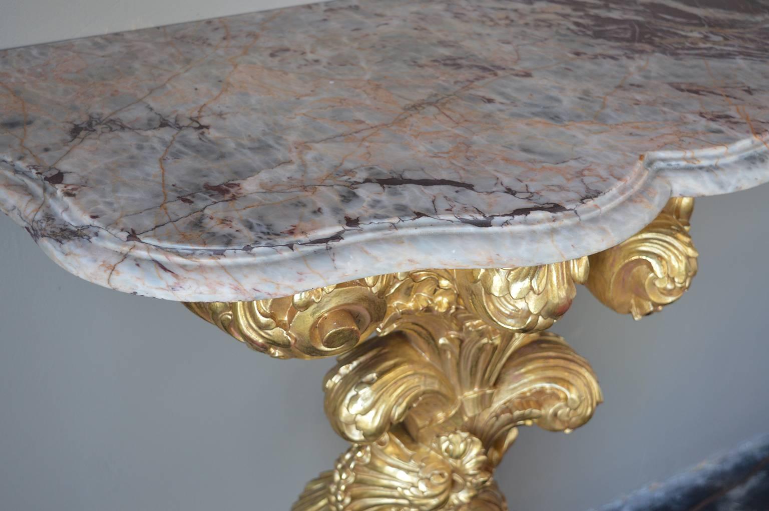 Hand-carved wood, gold leafed with marble top and base of feet.