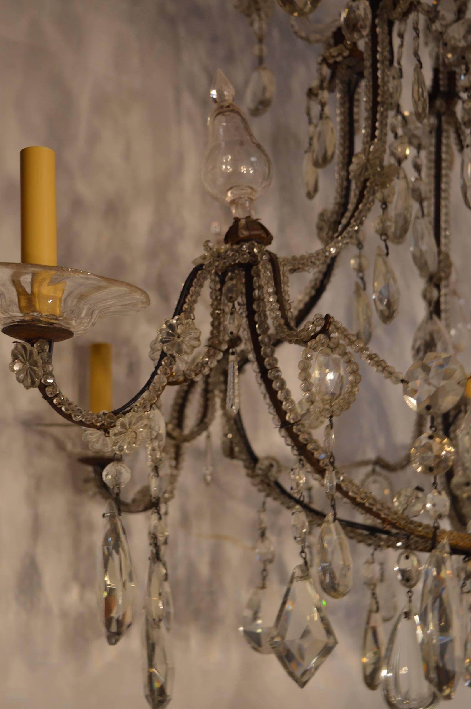 Italian crystal and Iron chandelier. Crystal beading along framework of the chandelier.