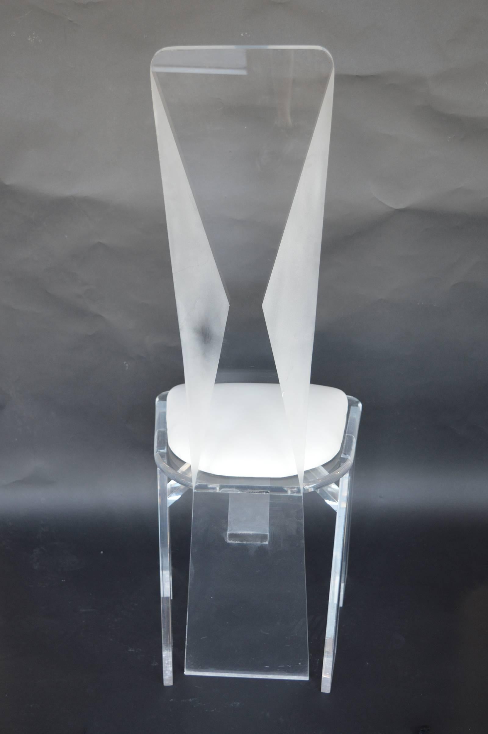 Set of eight Lucite dining chairs.