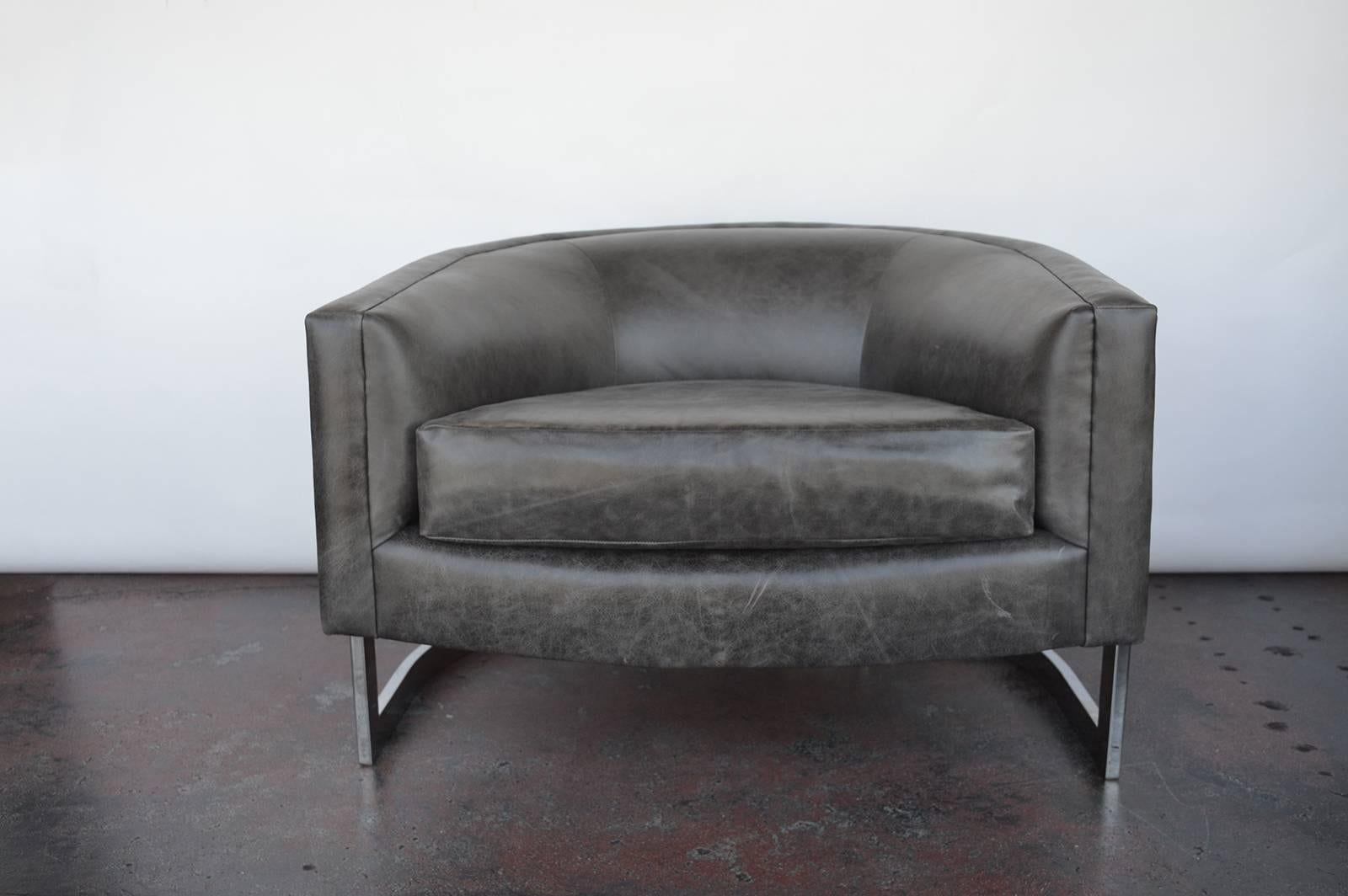 Pair of dark grey leather, armchairs with chrome frame.