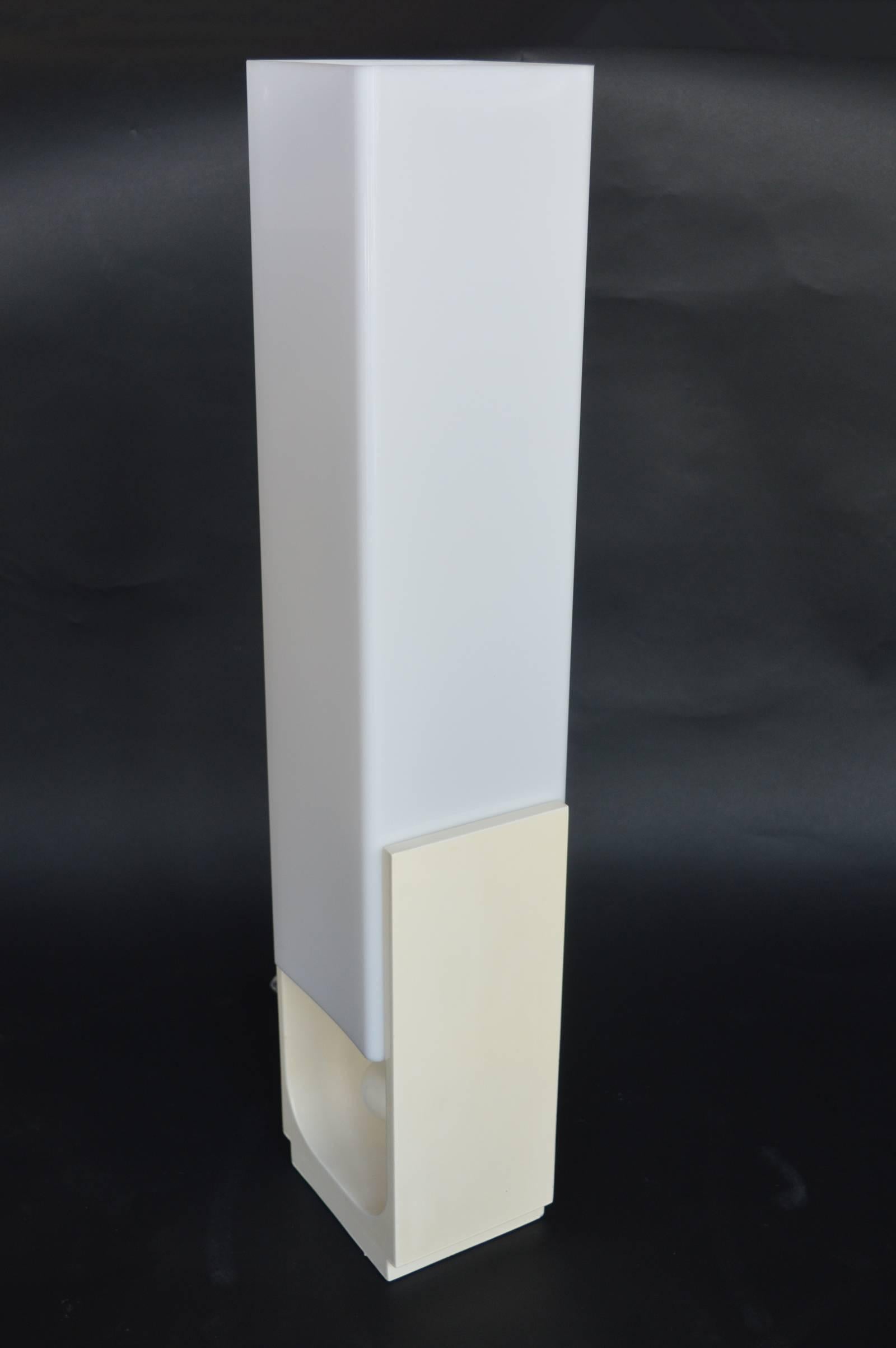 White lacquered wood base and white molded acrylic shade.