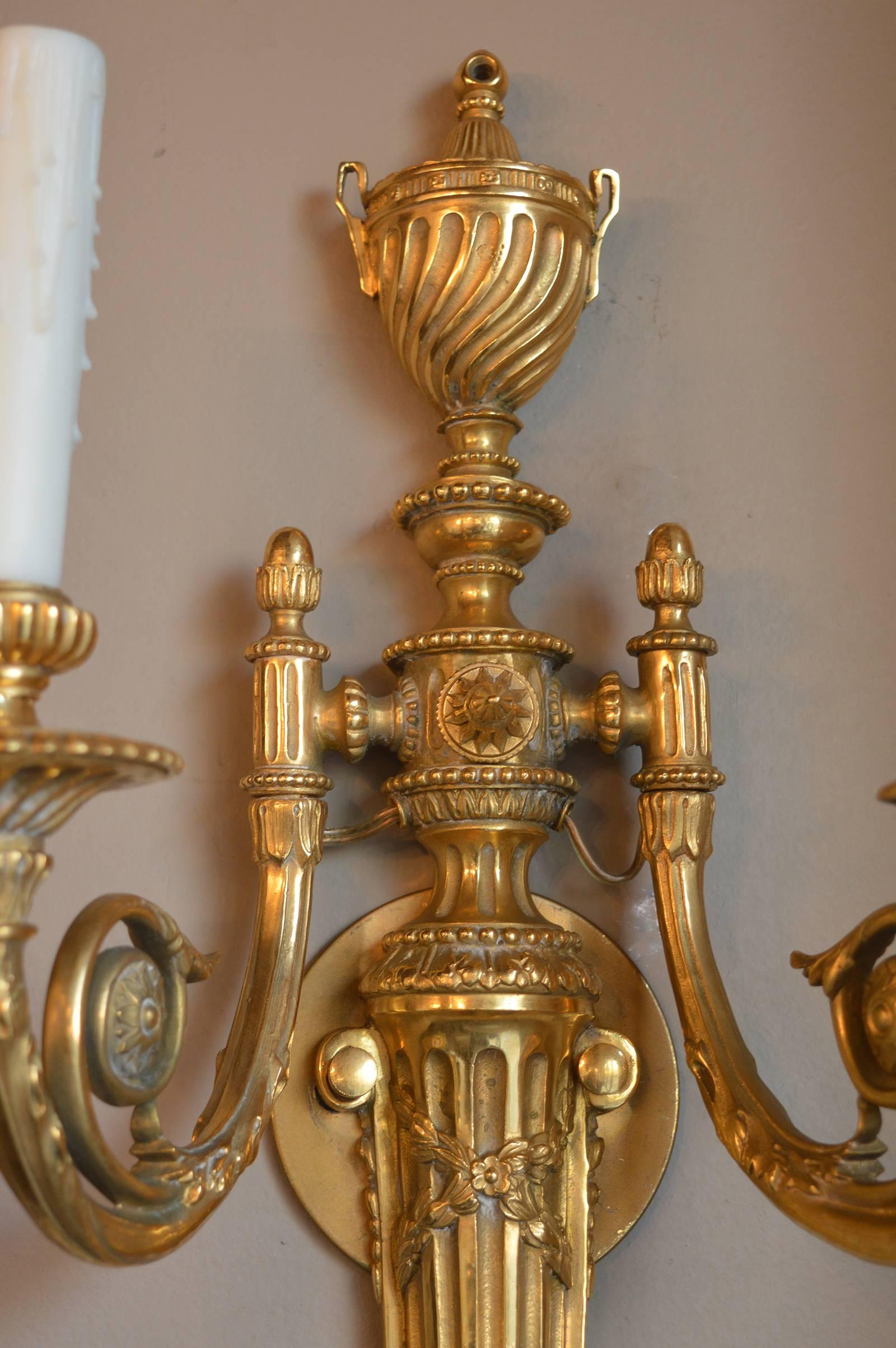 Set of four two-arm bronze sconces. Wired for US.