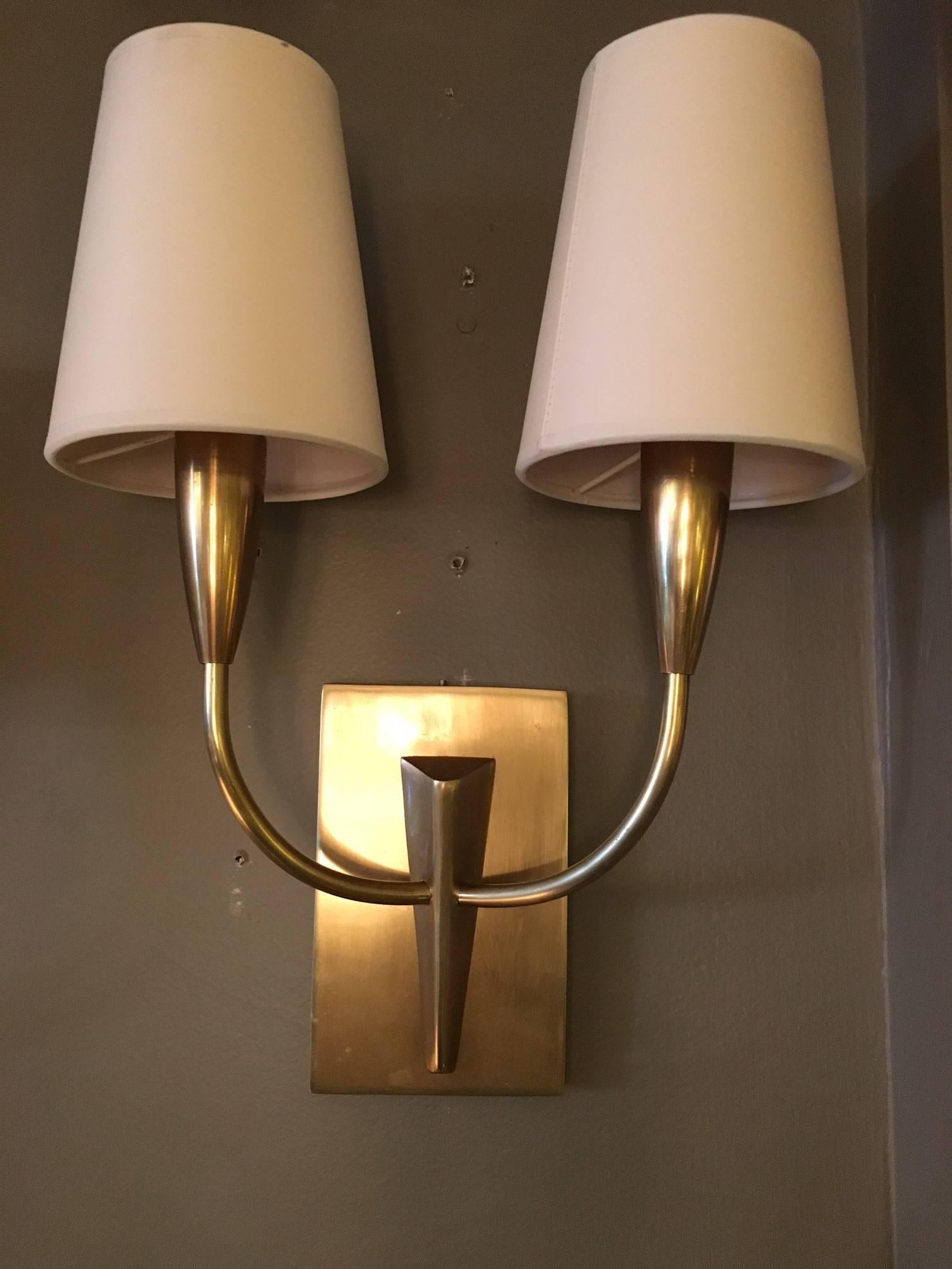 Pair of wall sconces with shades.