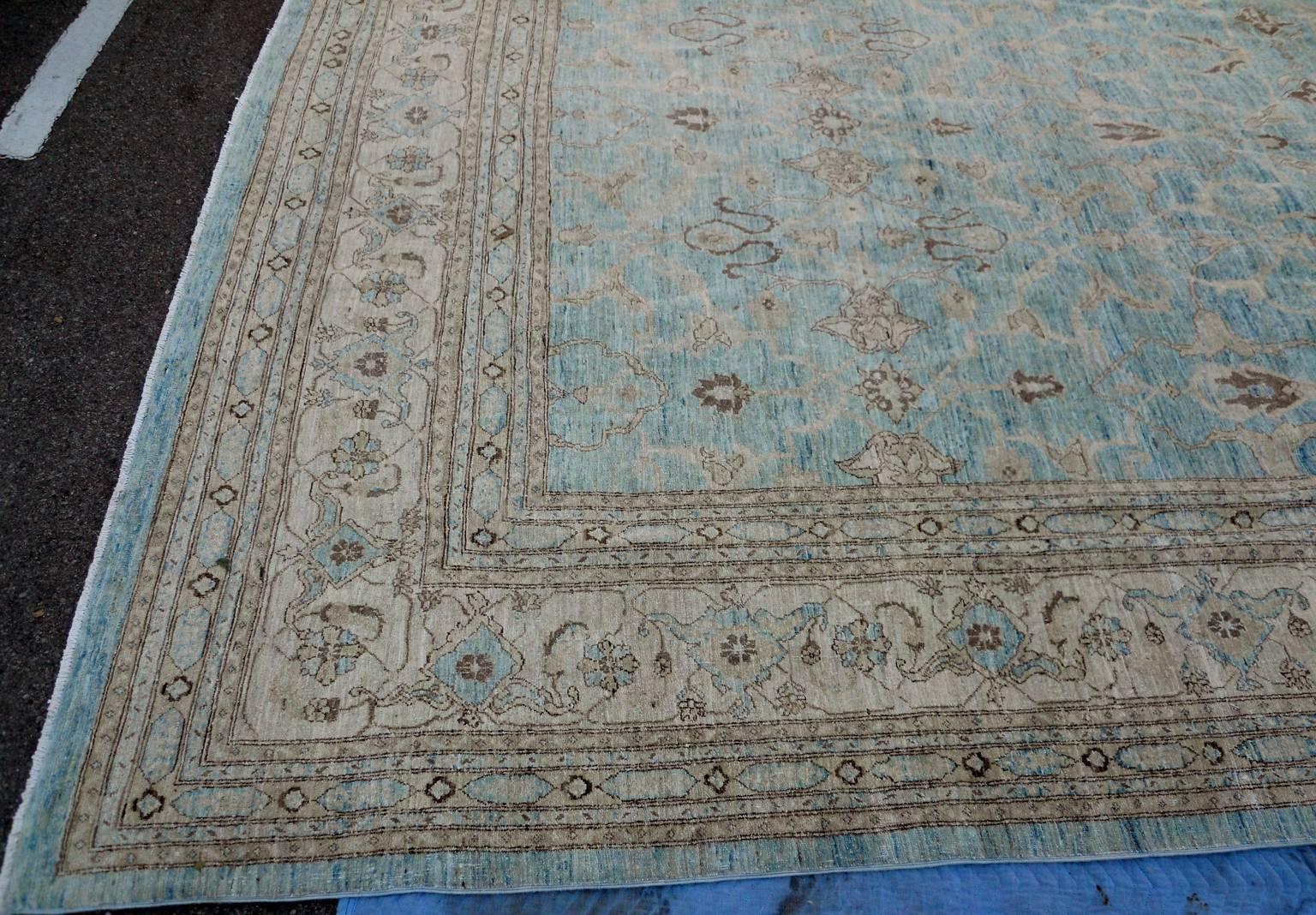 Finely handwoven blue and cream Oushak style rug.