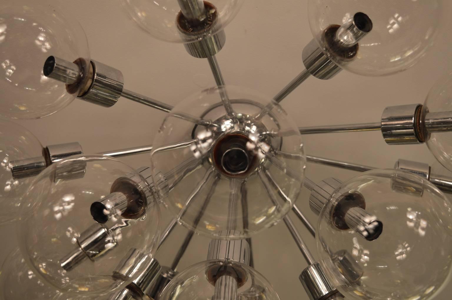 Glass Sputnik flush mount. Candelabra light bulbs at 15-20 watts. Chrome and glass.