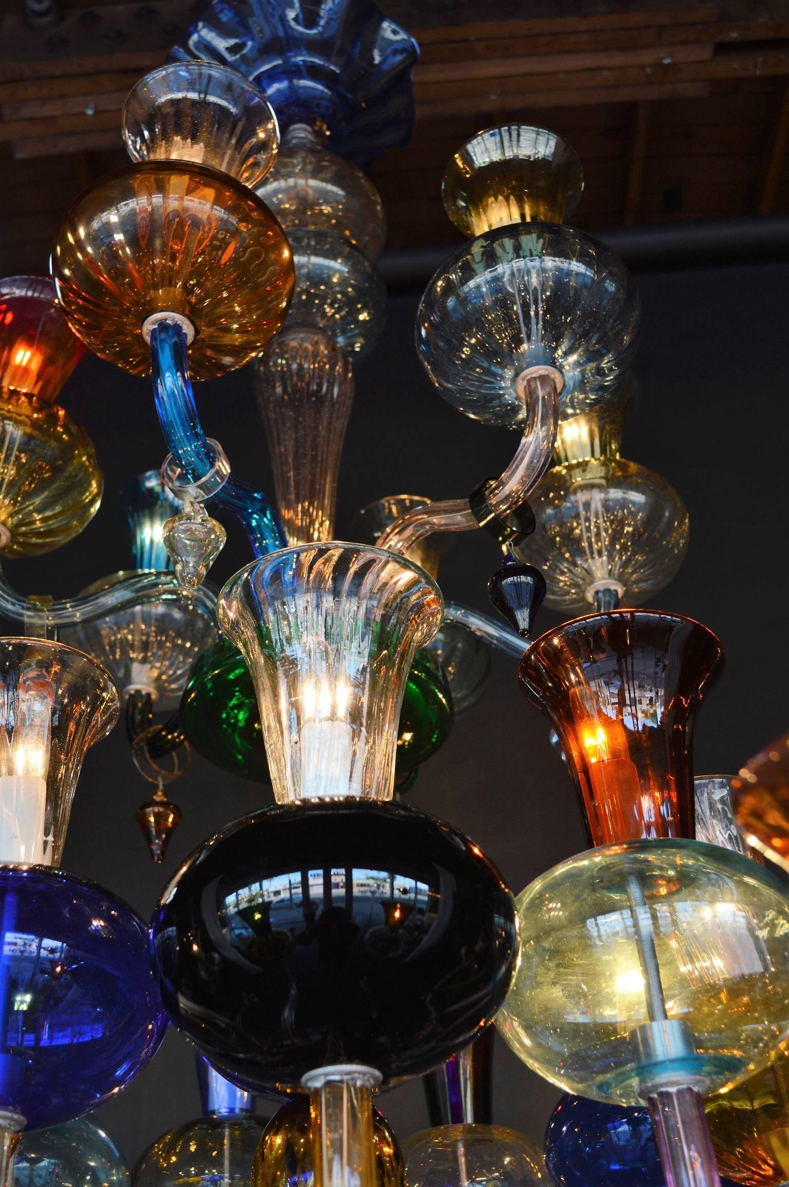 Large multicolored handblown glass chandelier. Each piece is different than another showcasing the chandelier's uniqueness.
 