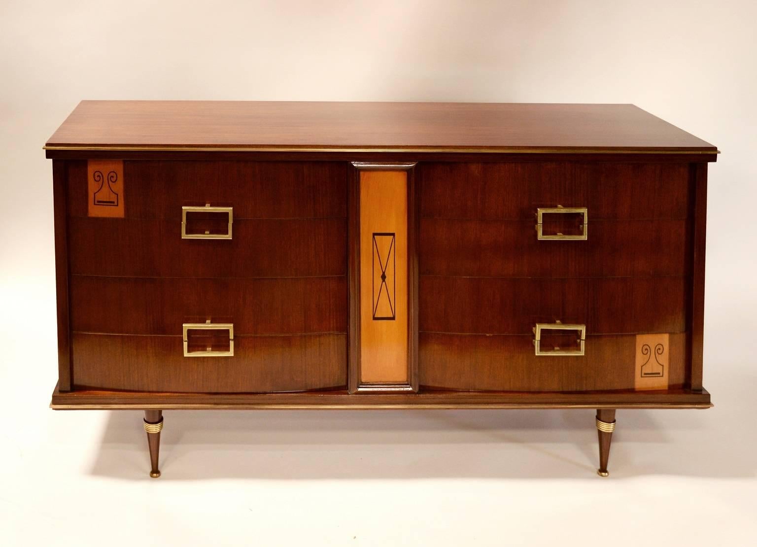 Italian mahogany and bronze eight-drawer commode. An Italian eight-drawer mahogany and bronze mounted commode resting on turned legs.