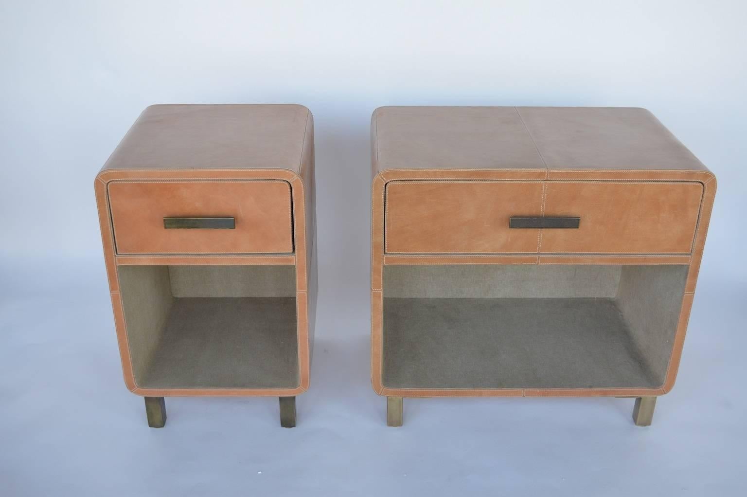 Pair of leather upholstered Italian nightstands.

Smaller nightstand measures: 28