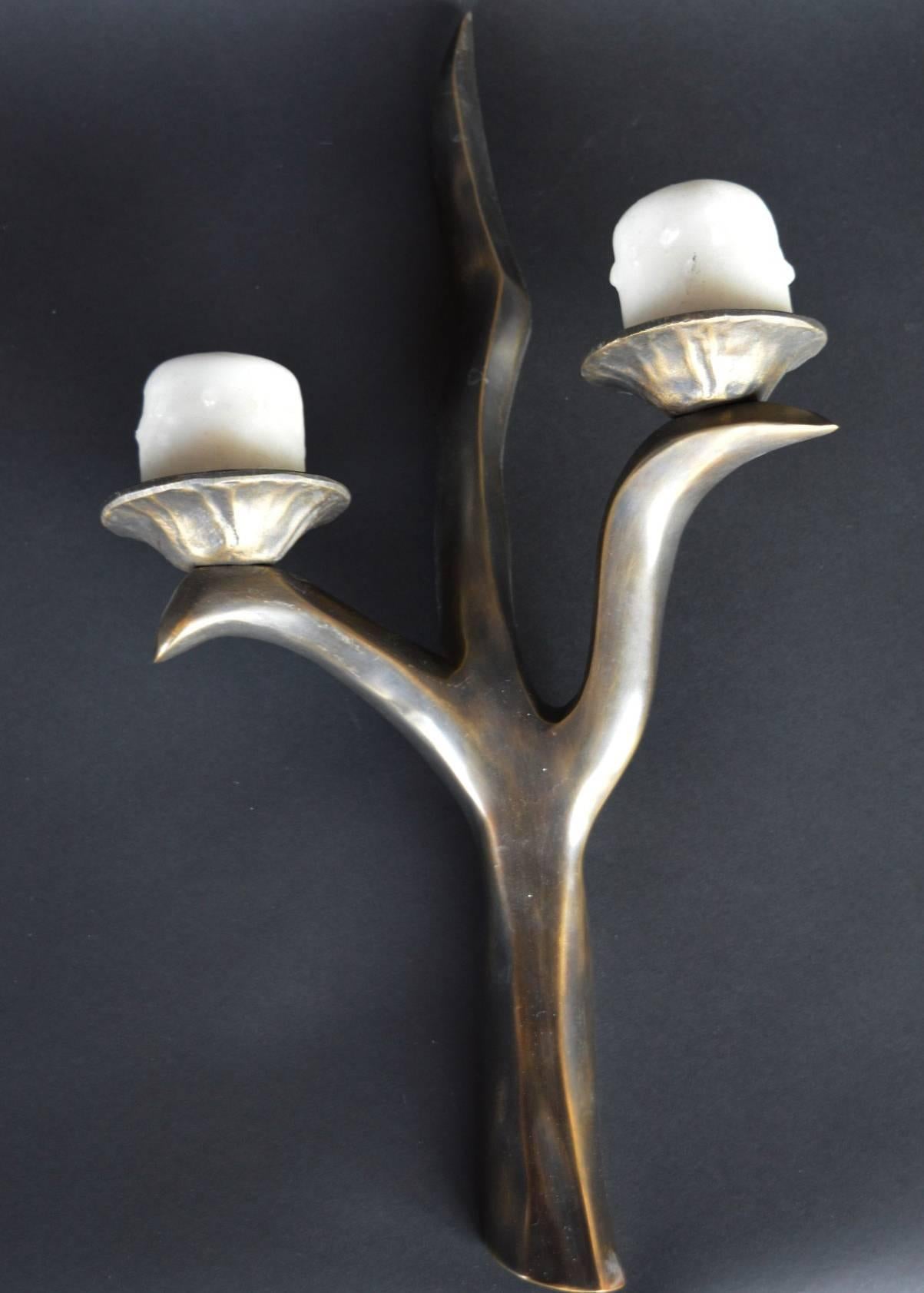 Set of three solid bronze sconces. Sconces look like branches holding lily pads.