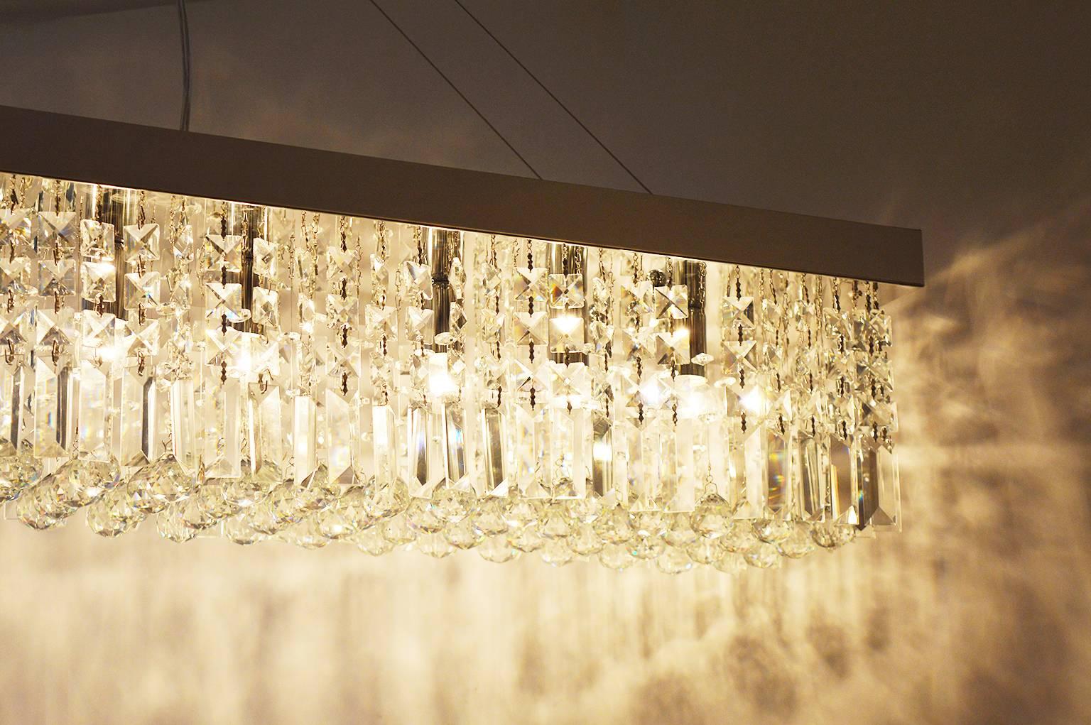 Long rectangular chandelier. Flush mount is adjustable.

Height of just the chandelier is 9 inches.
