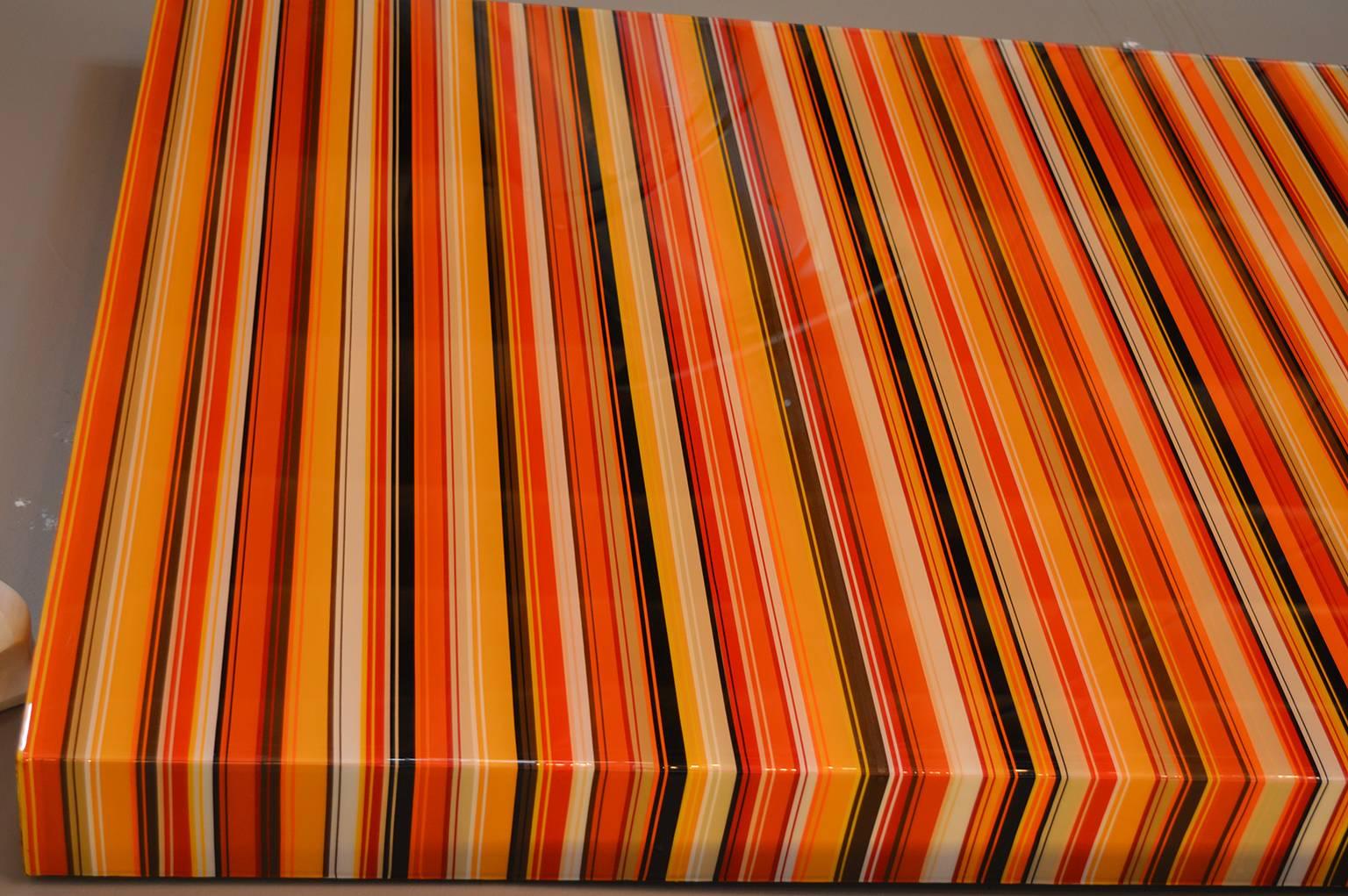 Tropicana made with thin pieces of tape, paint to create the striped look and then covered with resin.