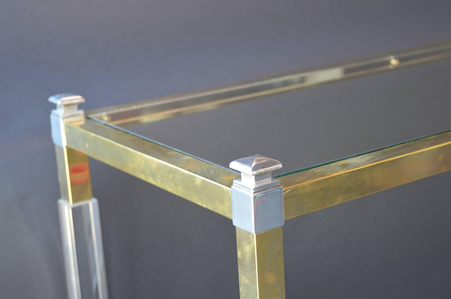 Lucite and brass framed console table.