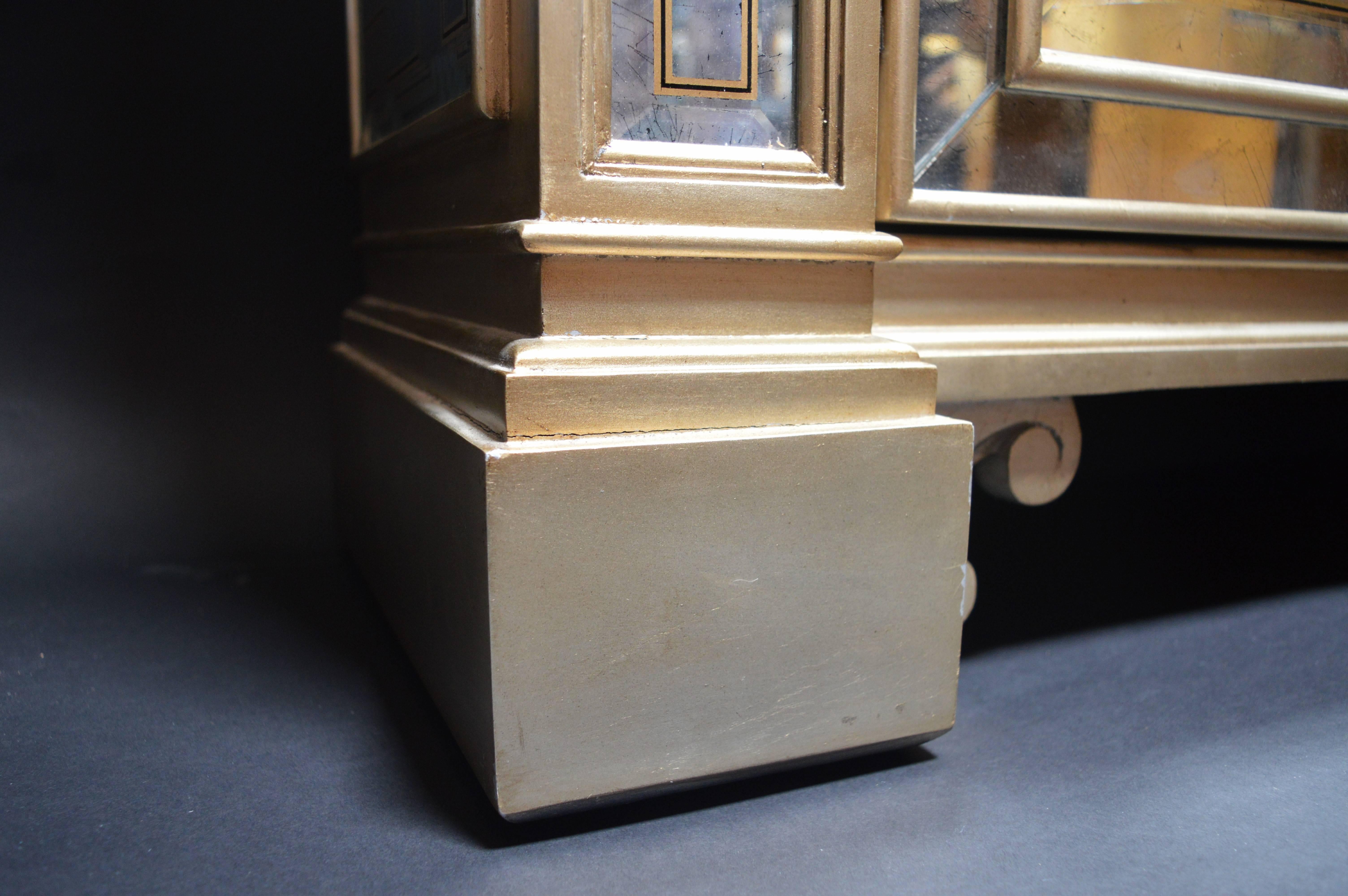 A white gold mirrored Ferguson Copeland commode with white gold leafed finish.