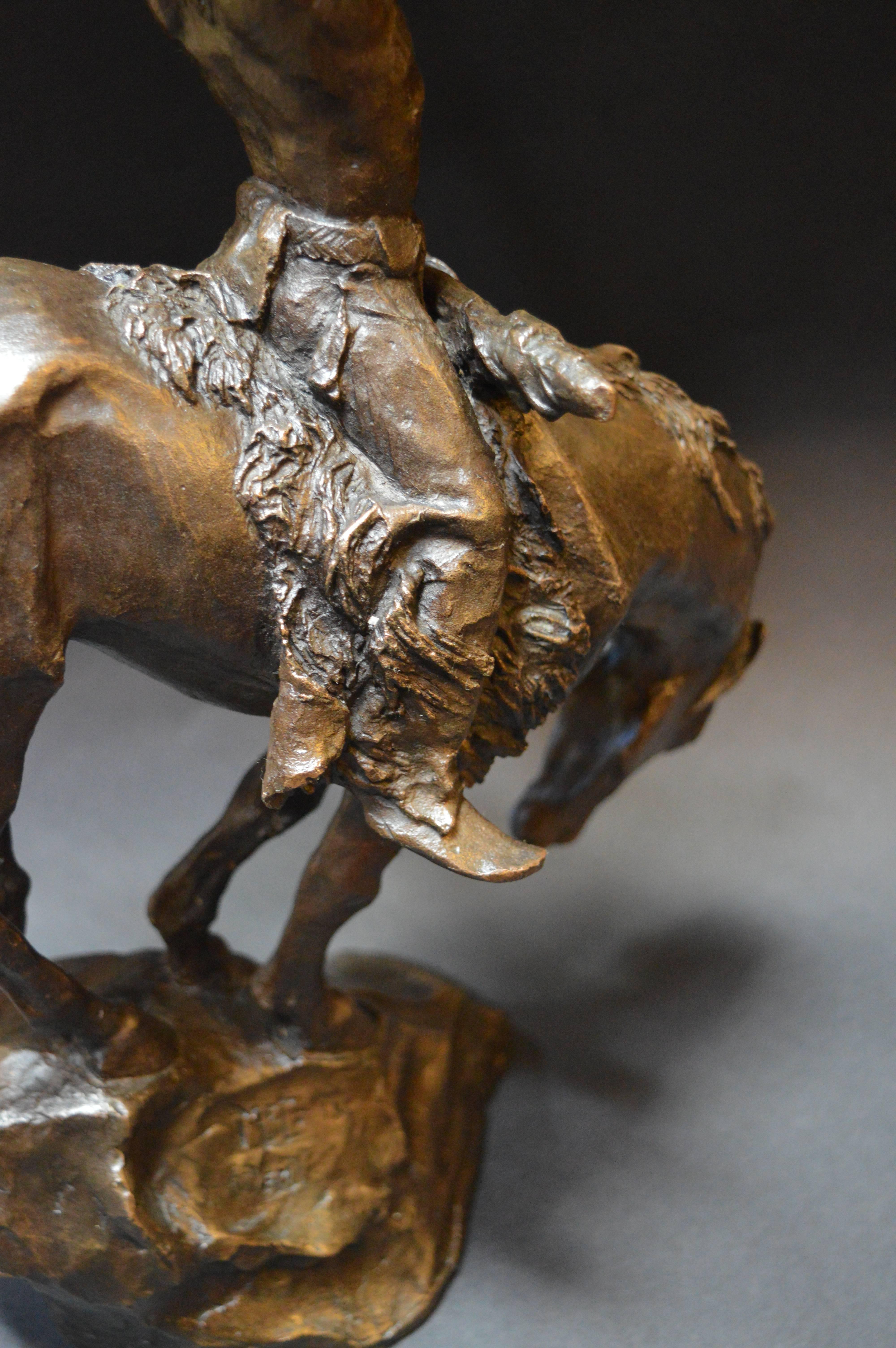 Bronze Native American on a horse holding a skull to the sky by Buck McCain. Signed 