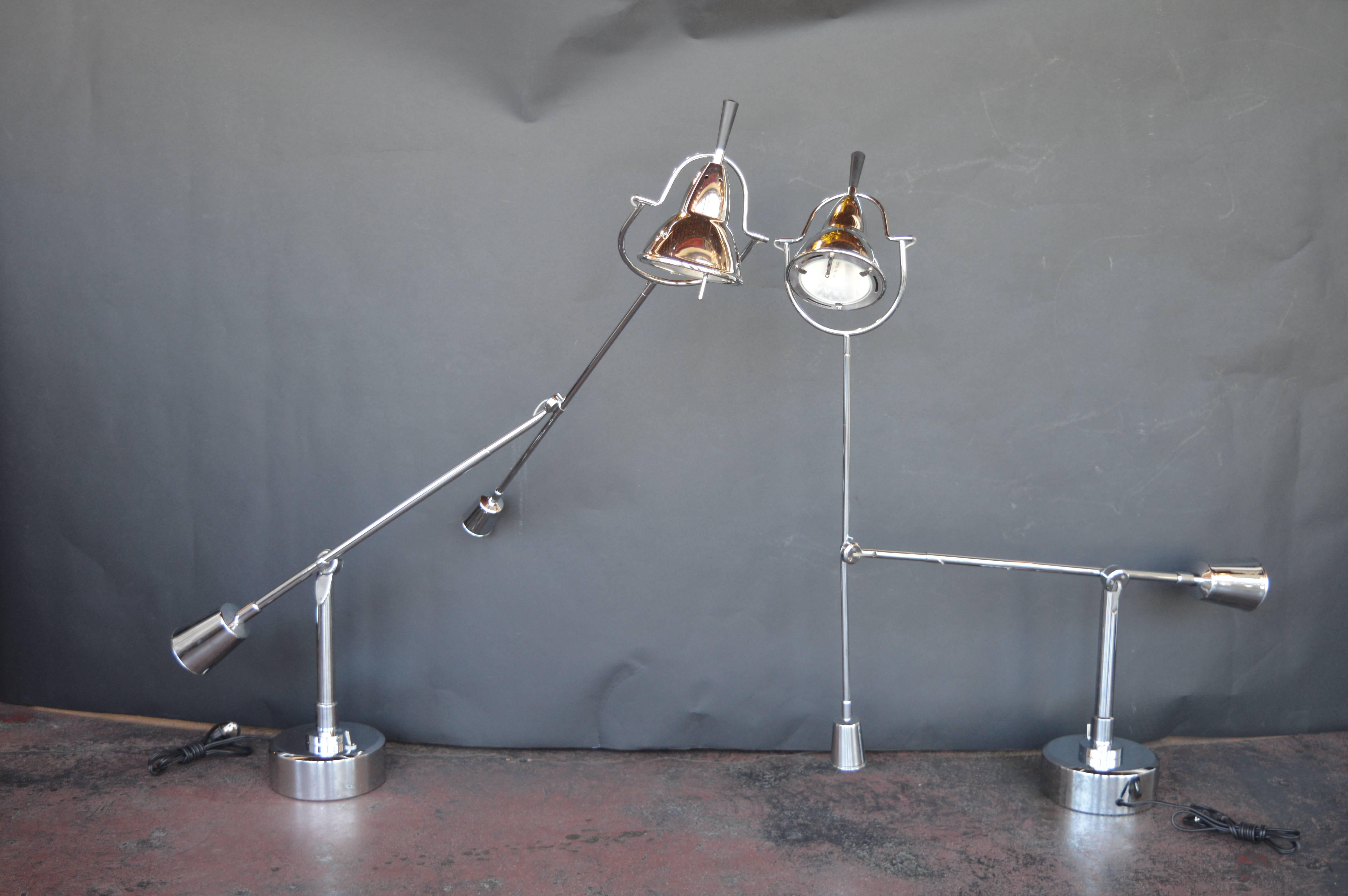 Pair of hinged chrome modern lamps. The lamps can be moved in any direction, they have great height but can also be lowered to be accommodating.