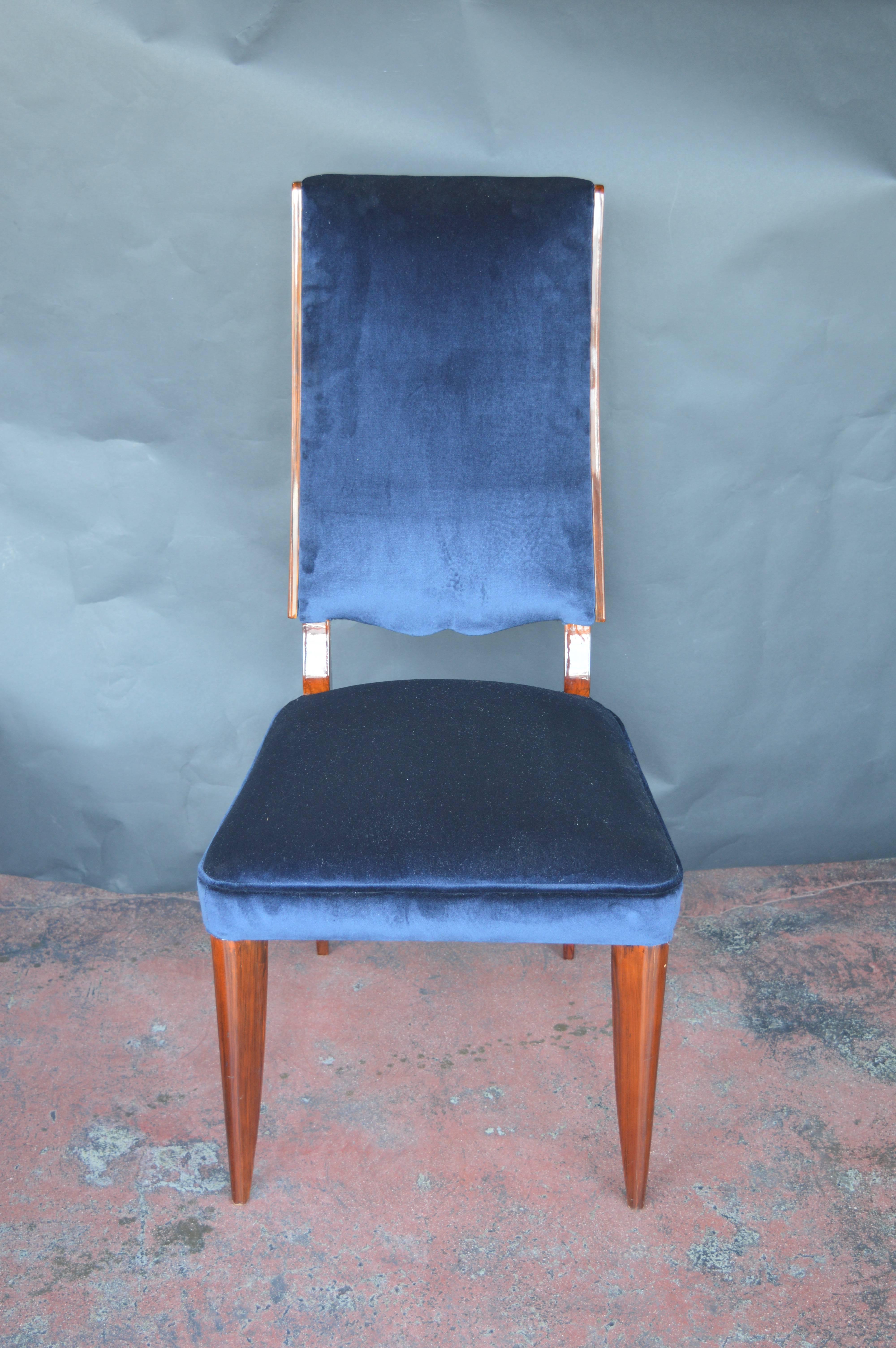 Set of eight French Art Deco dining chairs with blue velvet upholstery.