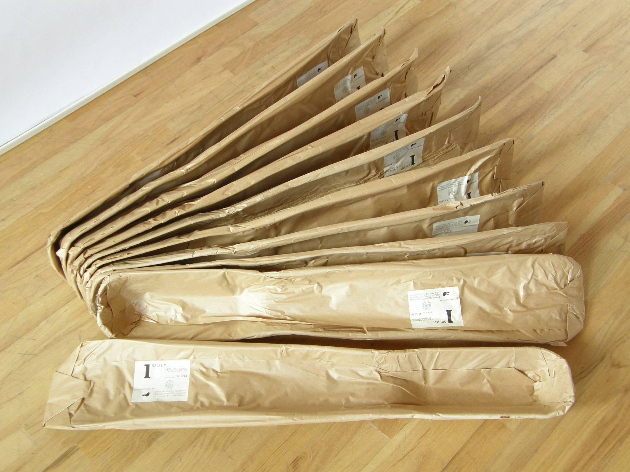 These leg splints were designed by Charles and Ray Eames and produced for the United States Navy by the Evans Products Company, molded plywood division. They're still in their original 1940s wrapping with the Ray Eames designed labels.

Each