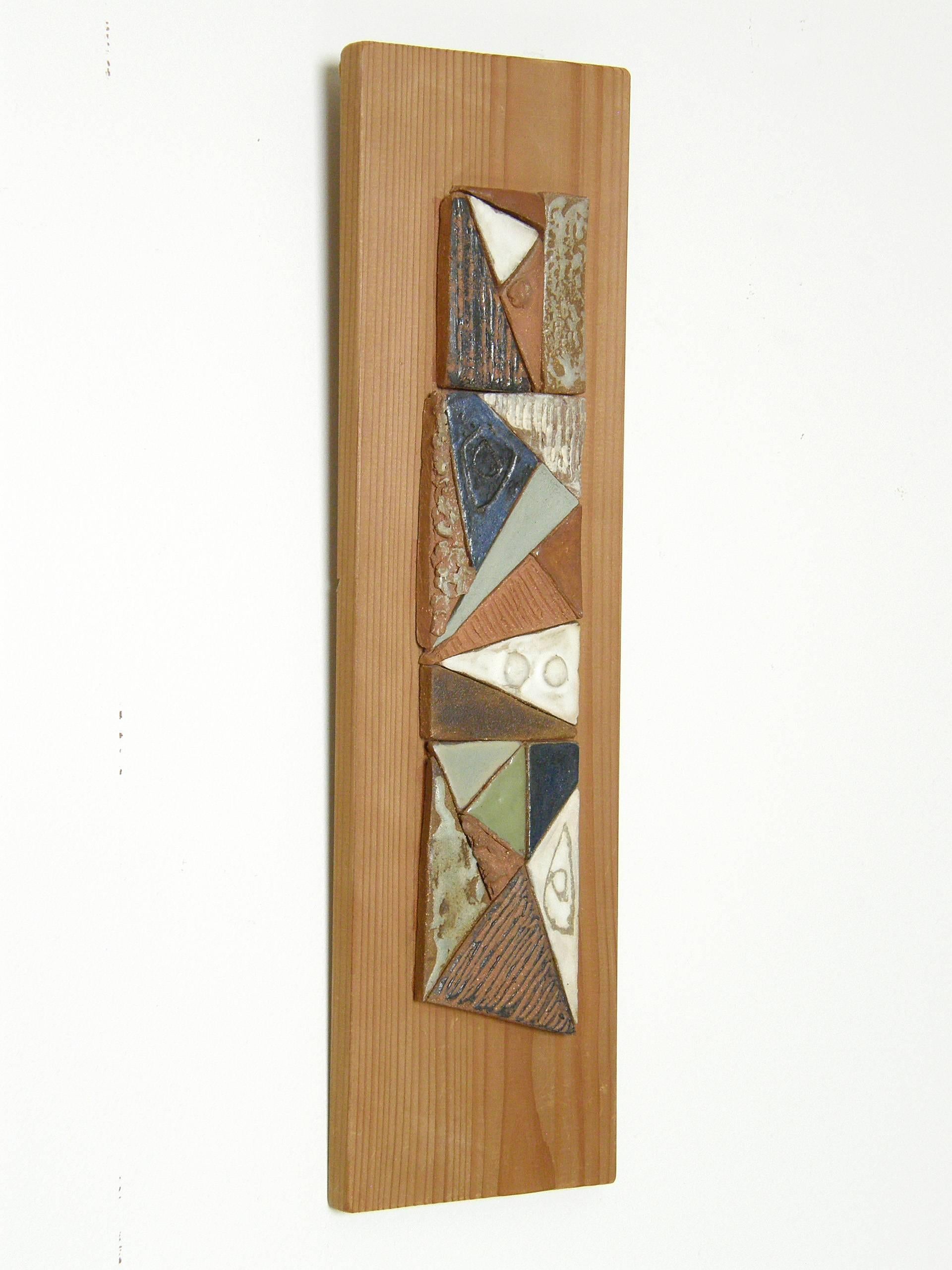 Abstract mosaic wall sculpture mounted on board by Illinois ceramic artist Peg Tootelian. The various textures and glazes create a kind of 