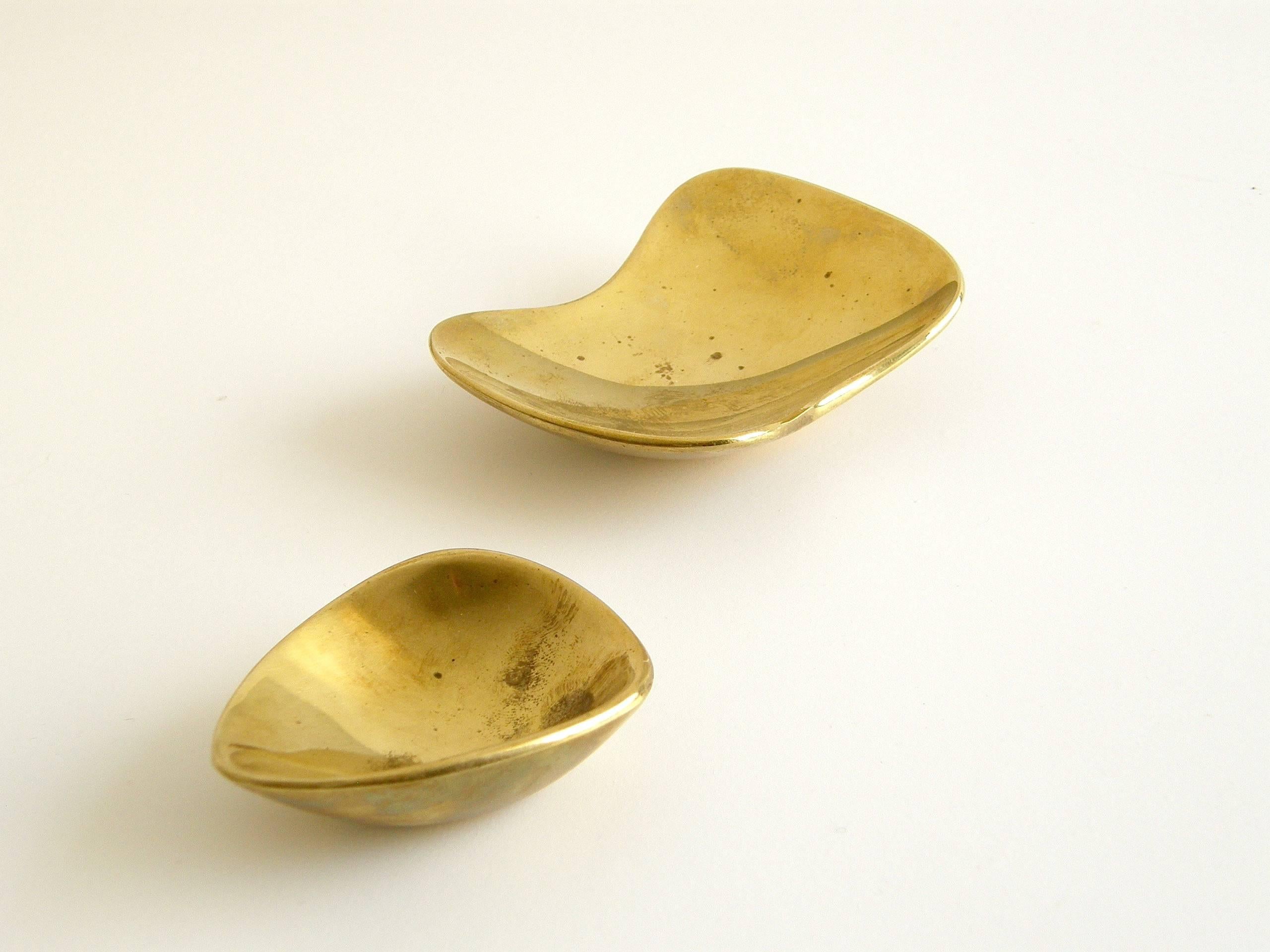Two miniature brass bowls or ashtrays by Carl Auböck. Their asymmetry and softly curving edges give them a playful and tactile quality. They are both unsigned, but one of them has remnants of a paper label from a retailer in Innsbruck.

smaller- 2