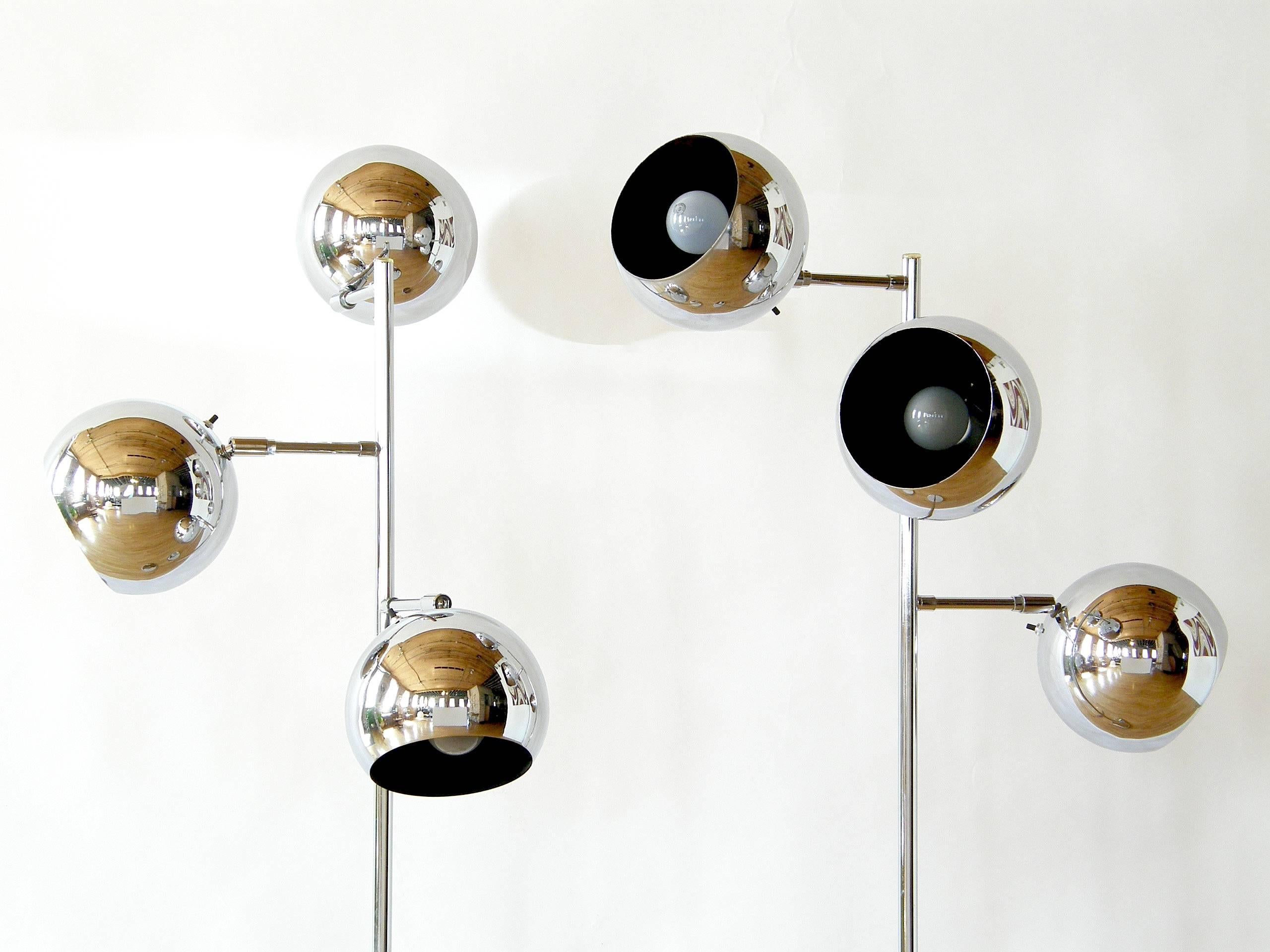 This pair of Koch & Lowy chrome floor lamps each have three tilting and pivoting eyeball shades set on slender stems. The shade diameters are 7.5