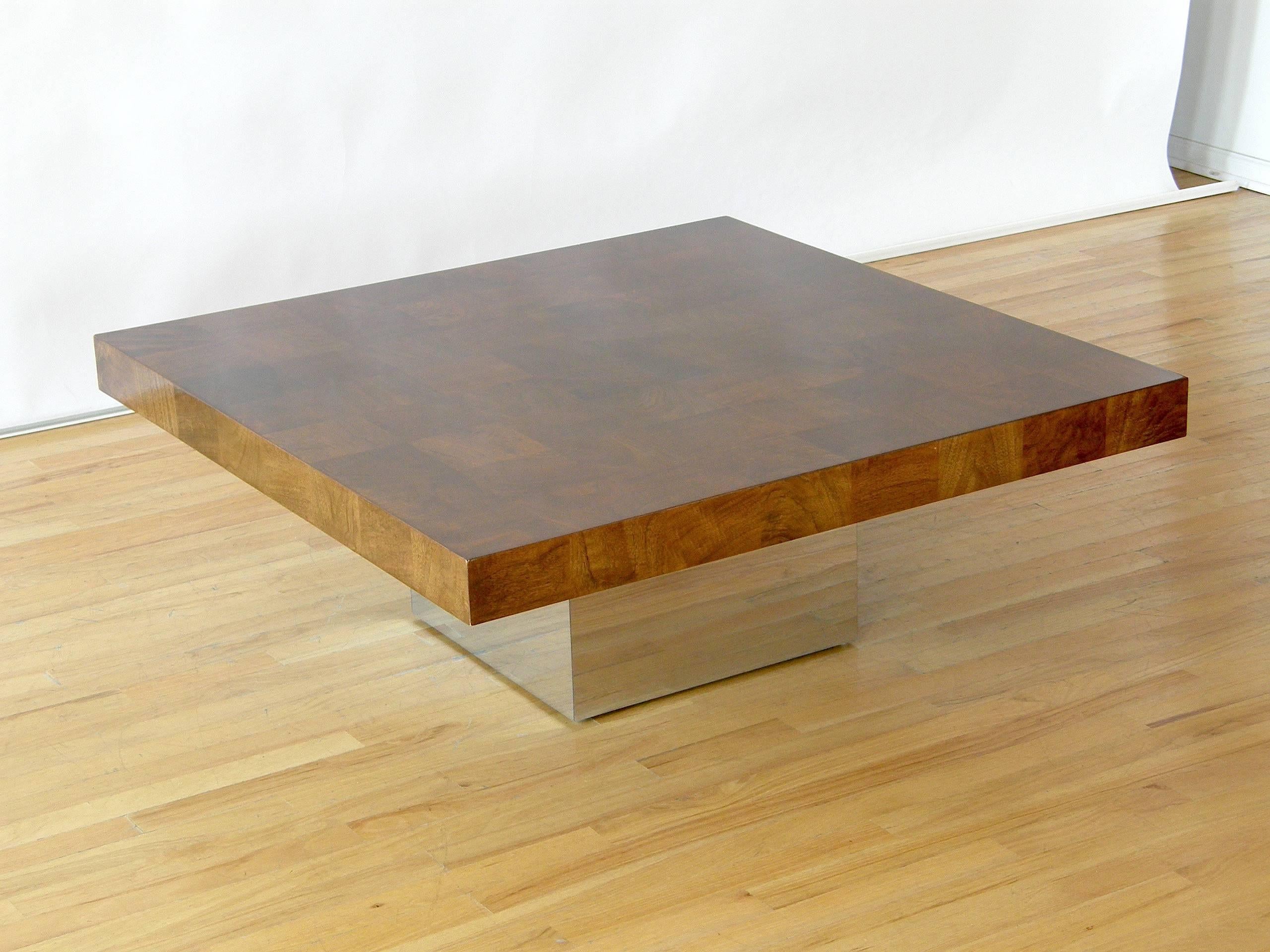 Square coffee table with walnut patchwork veneer top and chrome clad cube base designed by Milo Baughman.

Please contact us if you have any questions.