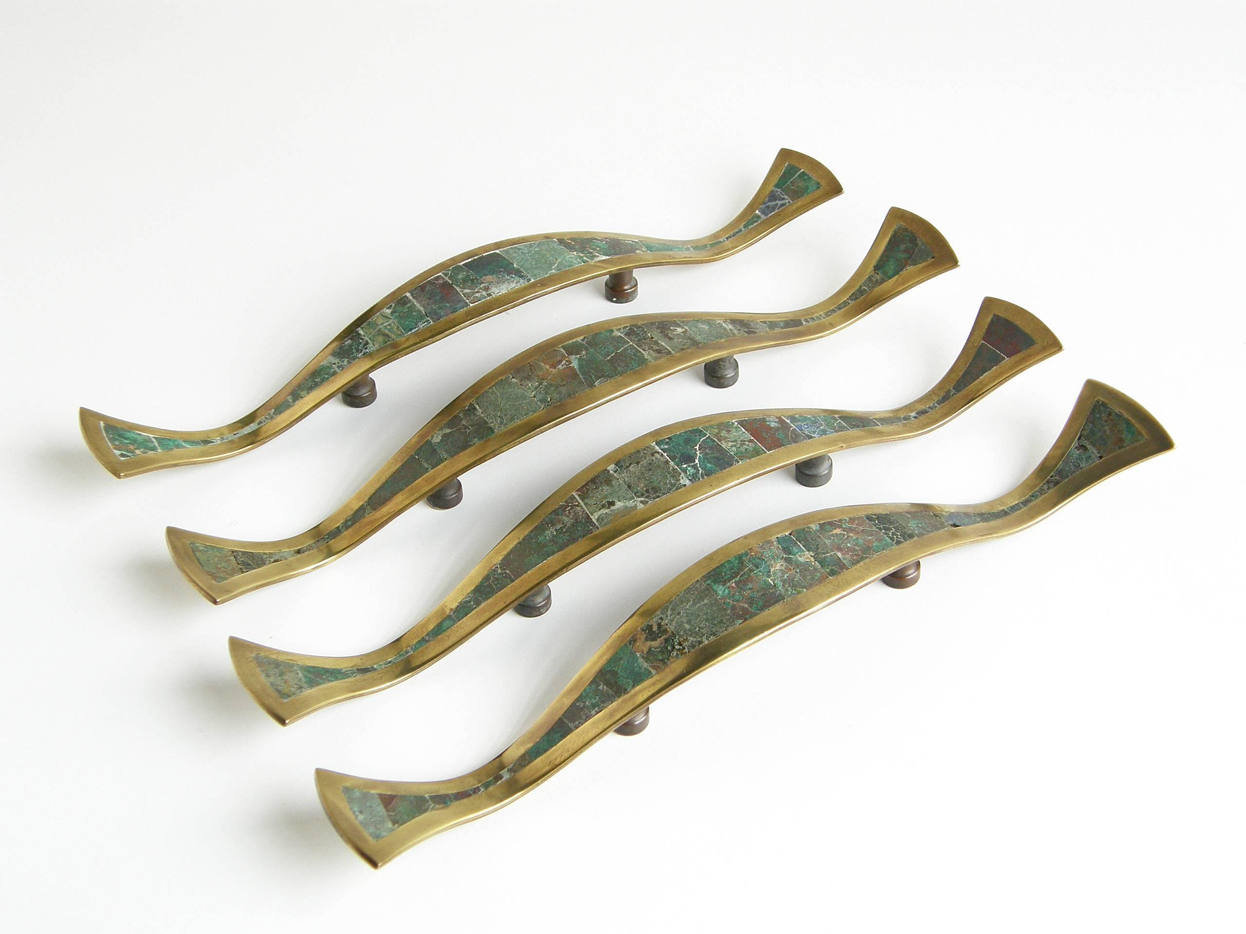 Set of four handmade door or drawer pulls from the Los Castillo workshop in Taxco, Mexico. They are sinuous in form with elegantly curved edges and profiles. 

Please contact us if you have any questions.