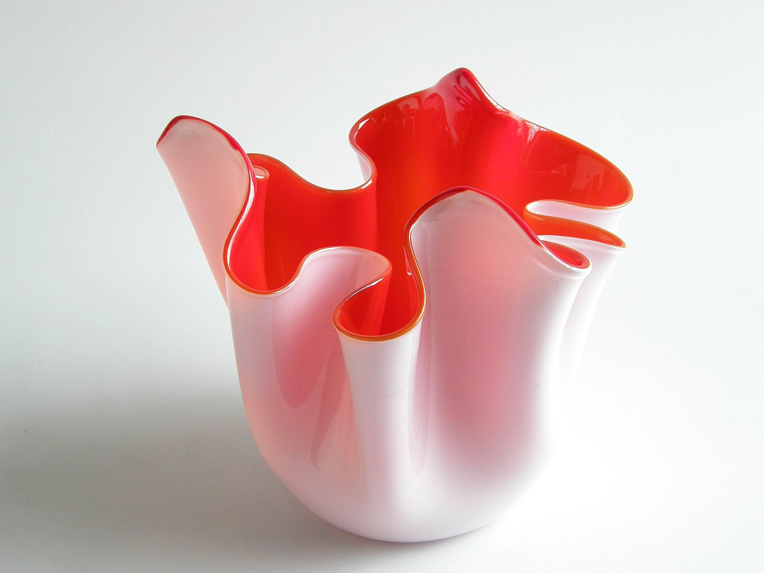 Wonderful, free-form handkerchief vase designed by Fulvio Bianconi for Venini of Murano, Italy. The rich red interior is cased in a white glass exterior. The undulating shape of this classic Venini 