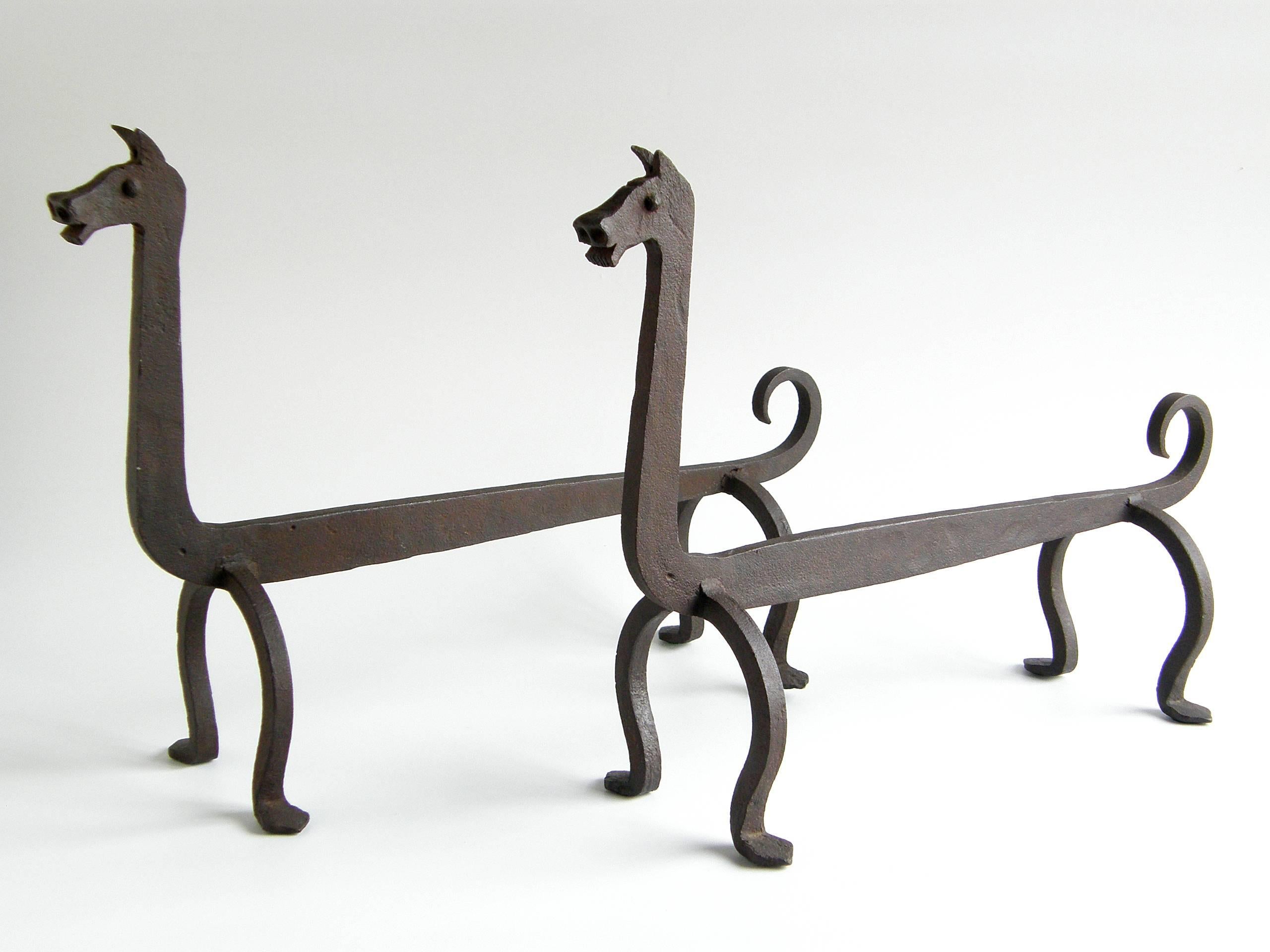 Stylized, hand-wrought iron log holders in the form of two dogs. They have a humorous quality with expressive faces, a wide-legged stance, long necks, and curled tails. They bring a playful tone to your fireplace.

Please contact us if you have