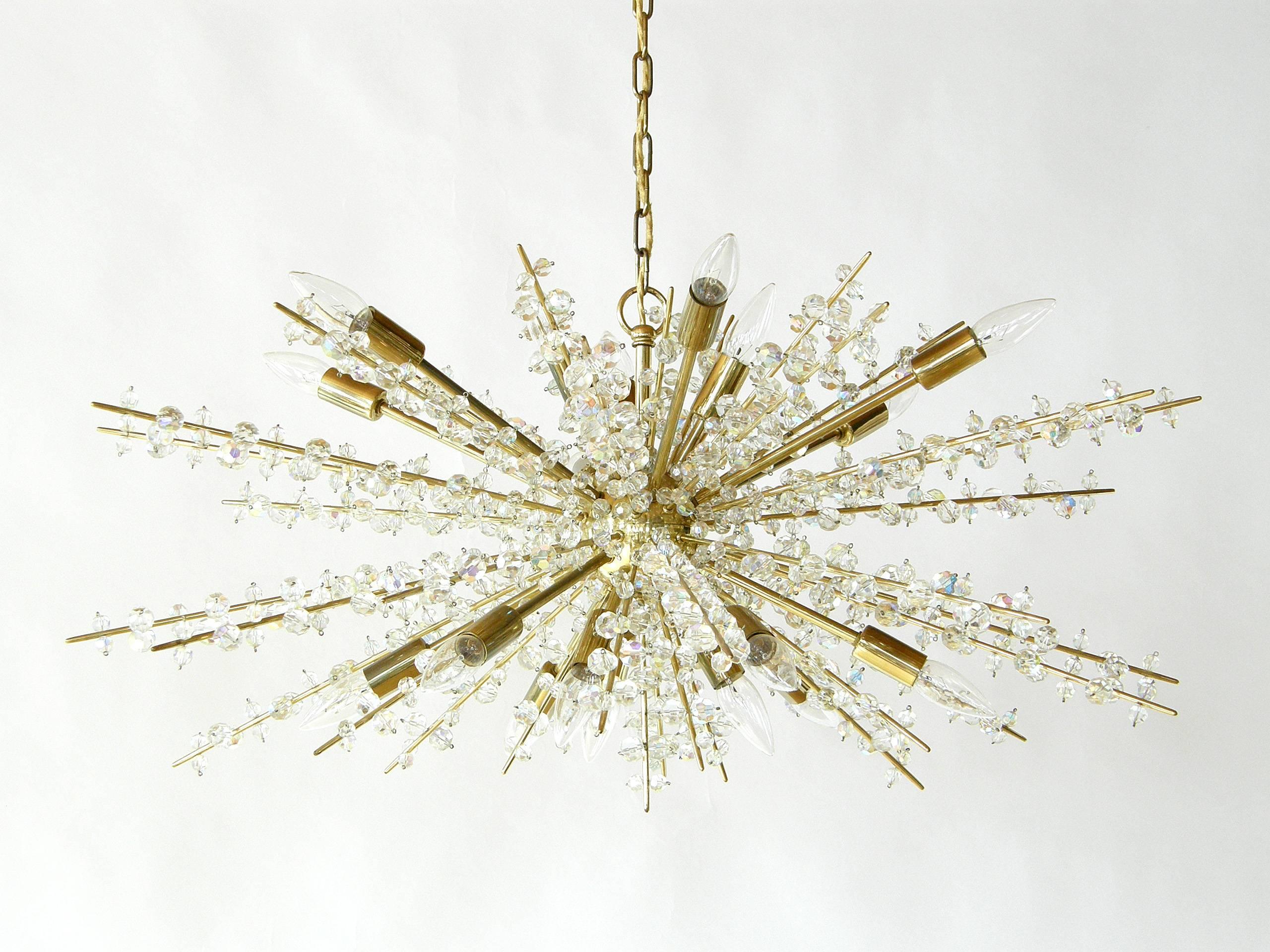 Dramatic and sparkling sputnik chandelier attributed to Bakalowits, Austria. The long spikes are laden with faceted crystals of different sizes. Matching pair of wall sconces are also available.

This fixture has a label from Lite Trend, who