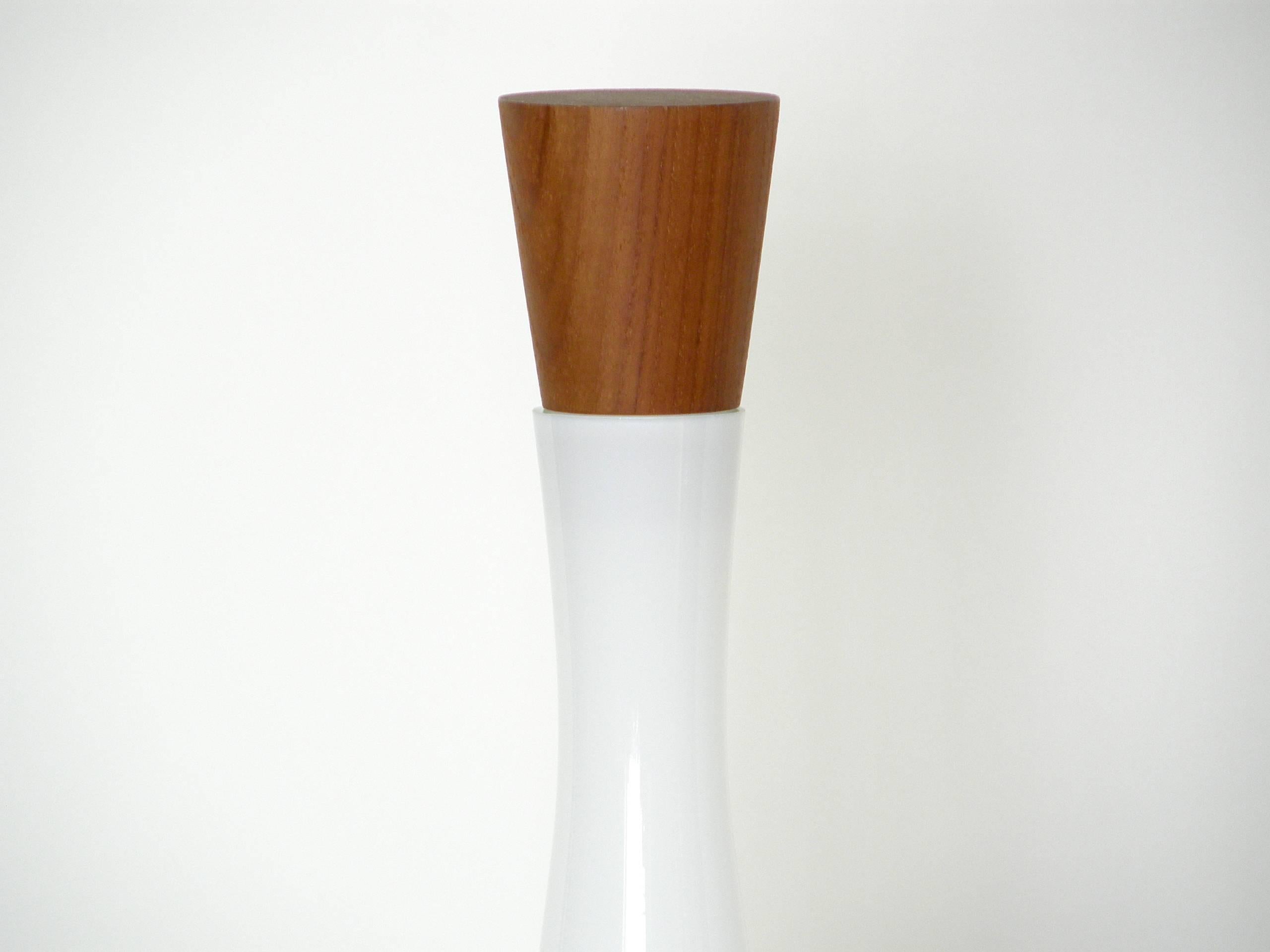 This elegant decanter in white cased glass with teak stopper was designed by Jacob Bang. It retains its original paper labels for Kastrup, the maker, and Raymor, the distributor.

Please contact us if you have any questions.