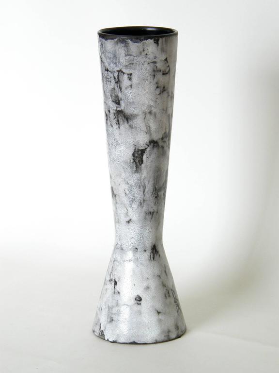 This tall ceramic vase has a double cone shape with a low 
