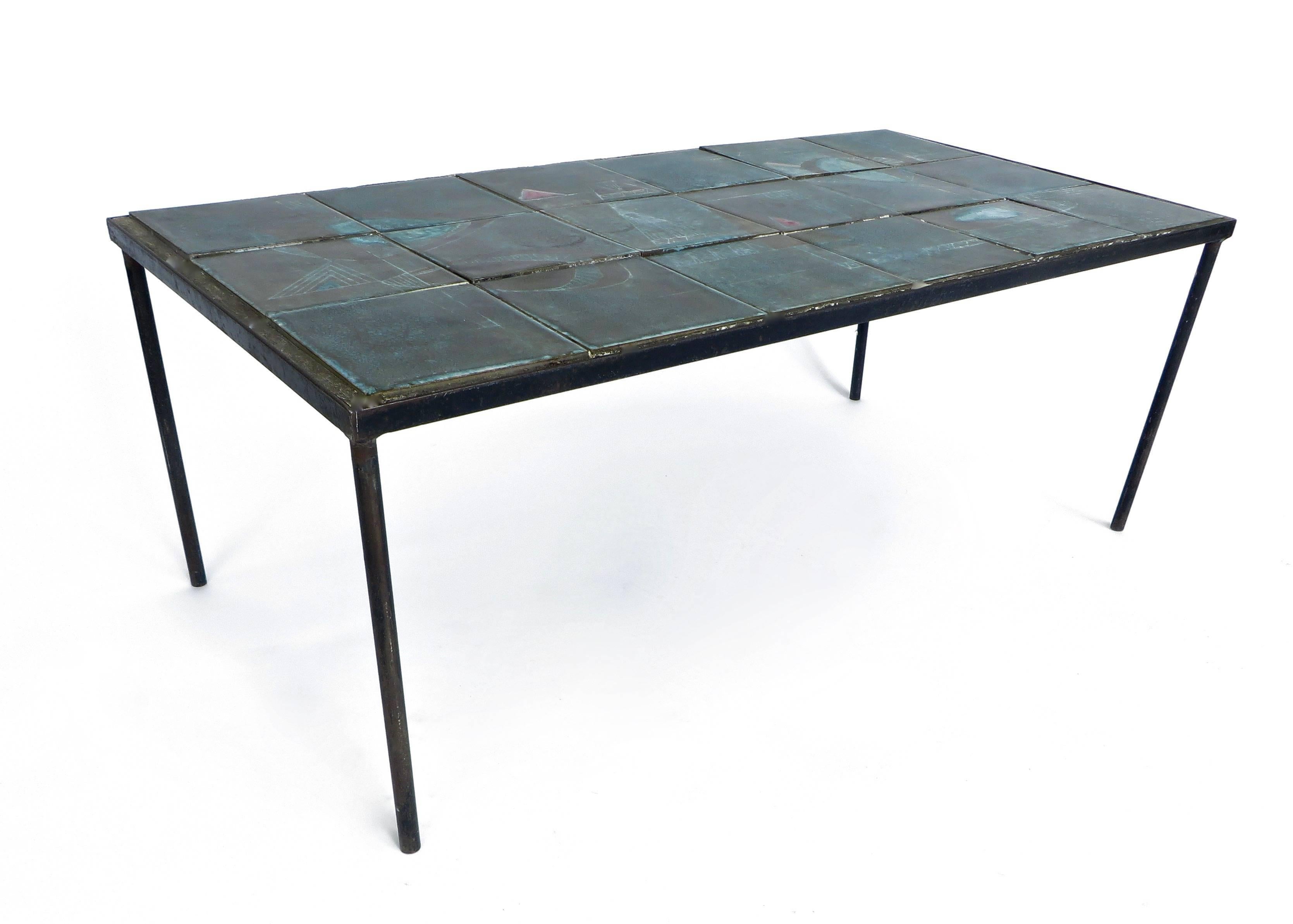 Ceramic tile toped table by Les Deux Potiers (Robert Charlier & Pierre Langlé) in the iconic blue glaze they were so well-known for with a wonderful iconic abstract painted motif. Unsigned. 
Similar to many that appear in the book Les 2 Potiers by