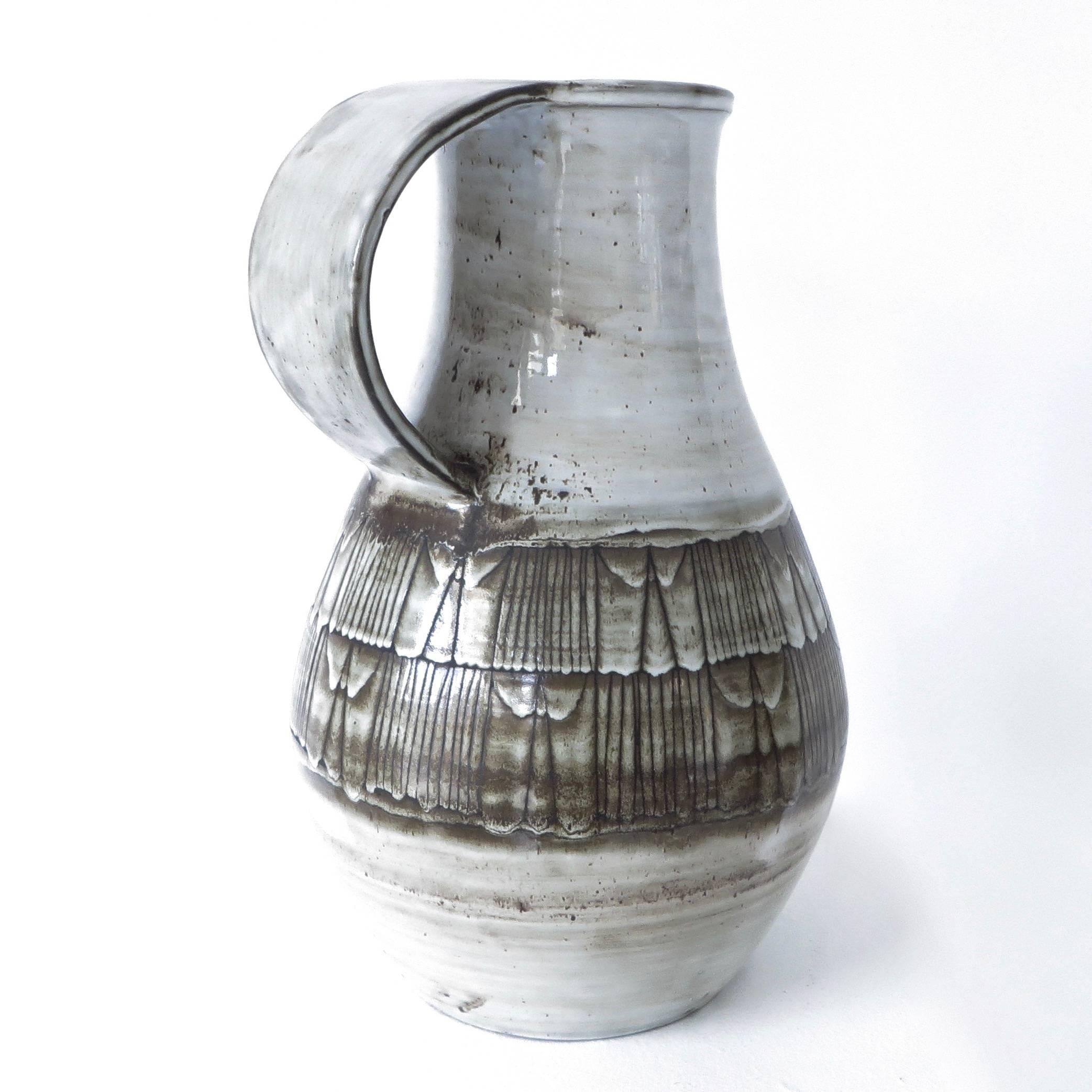 French ceramic monumental pitcher vessel by Jacques Pouchain Atelier Dieulefit in cream glaze and with brown geometric decoration.
Signed.
Excellent condition with no chips or cracks or restorations.
Born in 1925 Jacques Pouchain left Paris and