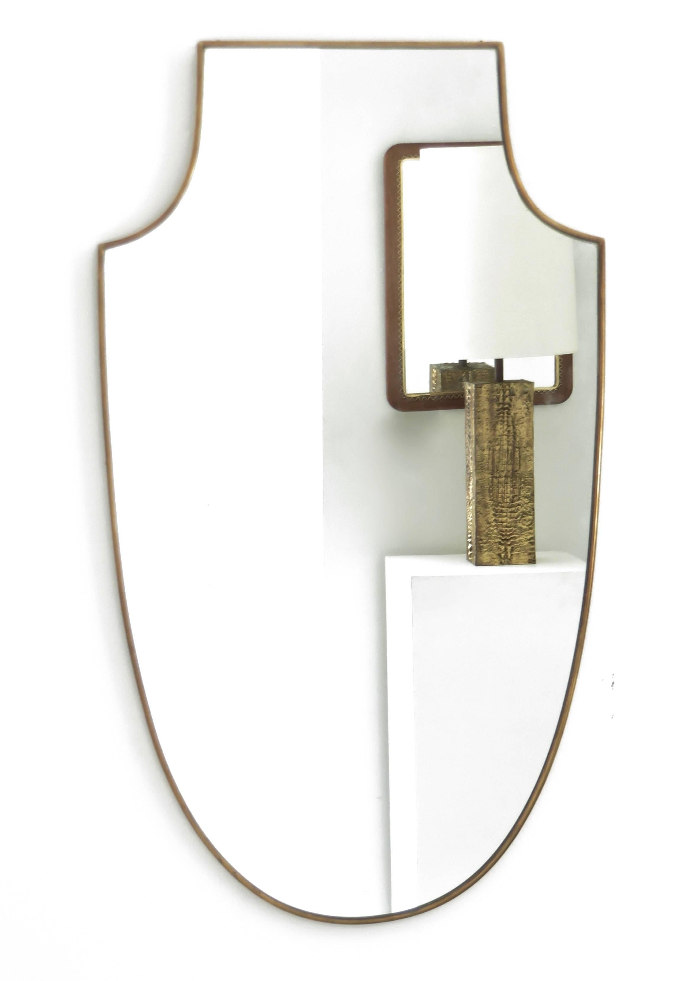 An Italian brass shield shaped framed mirror in excellent condition. 
Vintage c 1940. Excellent condition. 