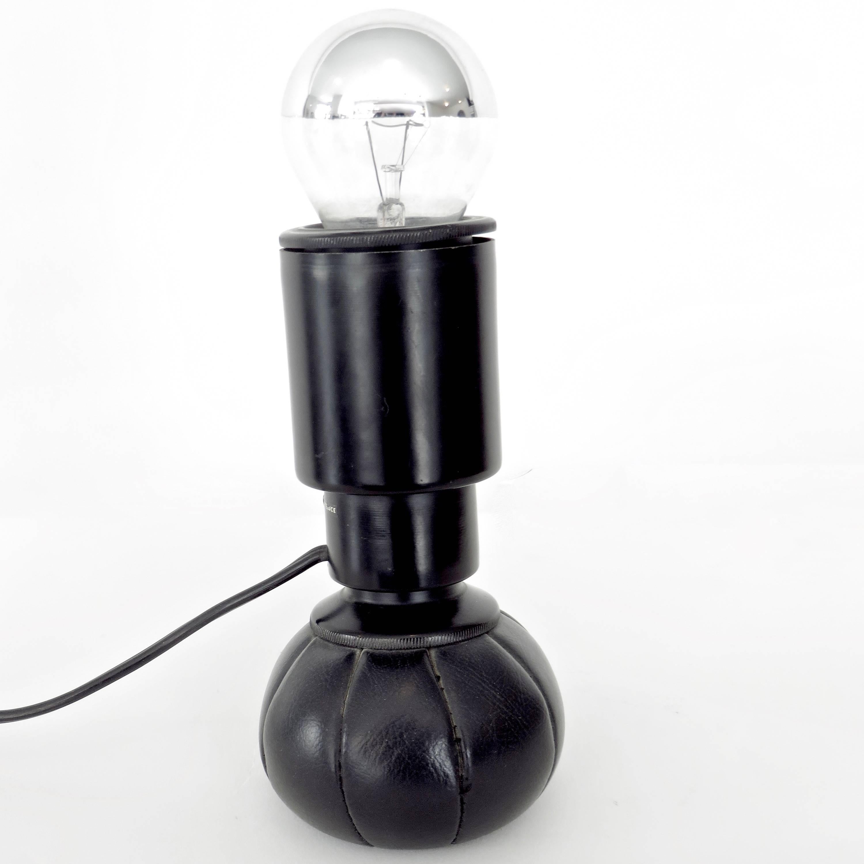 Rare first edition of the 600G lamp by Gino Sarfatti for Arteluce, 1966. 
This is from the first production with the original early Arteluce label. This lamp was made of black lacquered aluminum and has a leather weighted base. The lamp is in