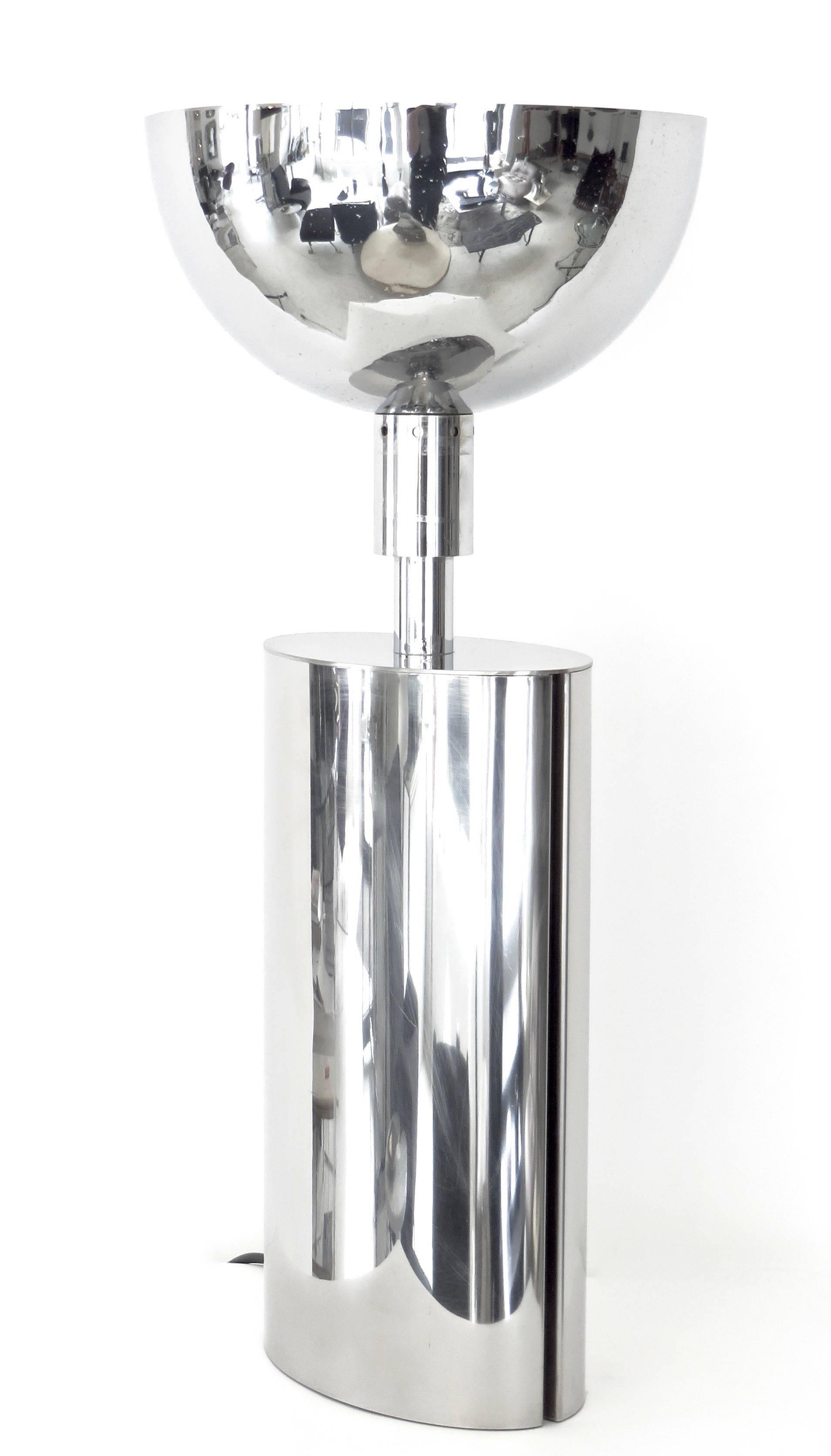 A French chrome-plated brass sculptural table lamp, circa 1970 with a removable white painted interior reflecting bowl shaped shade casting the light up. The rolled edge on each side creates a negative space.
Very high quality fabrication. One