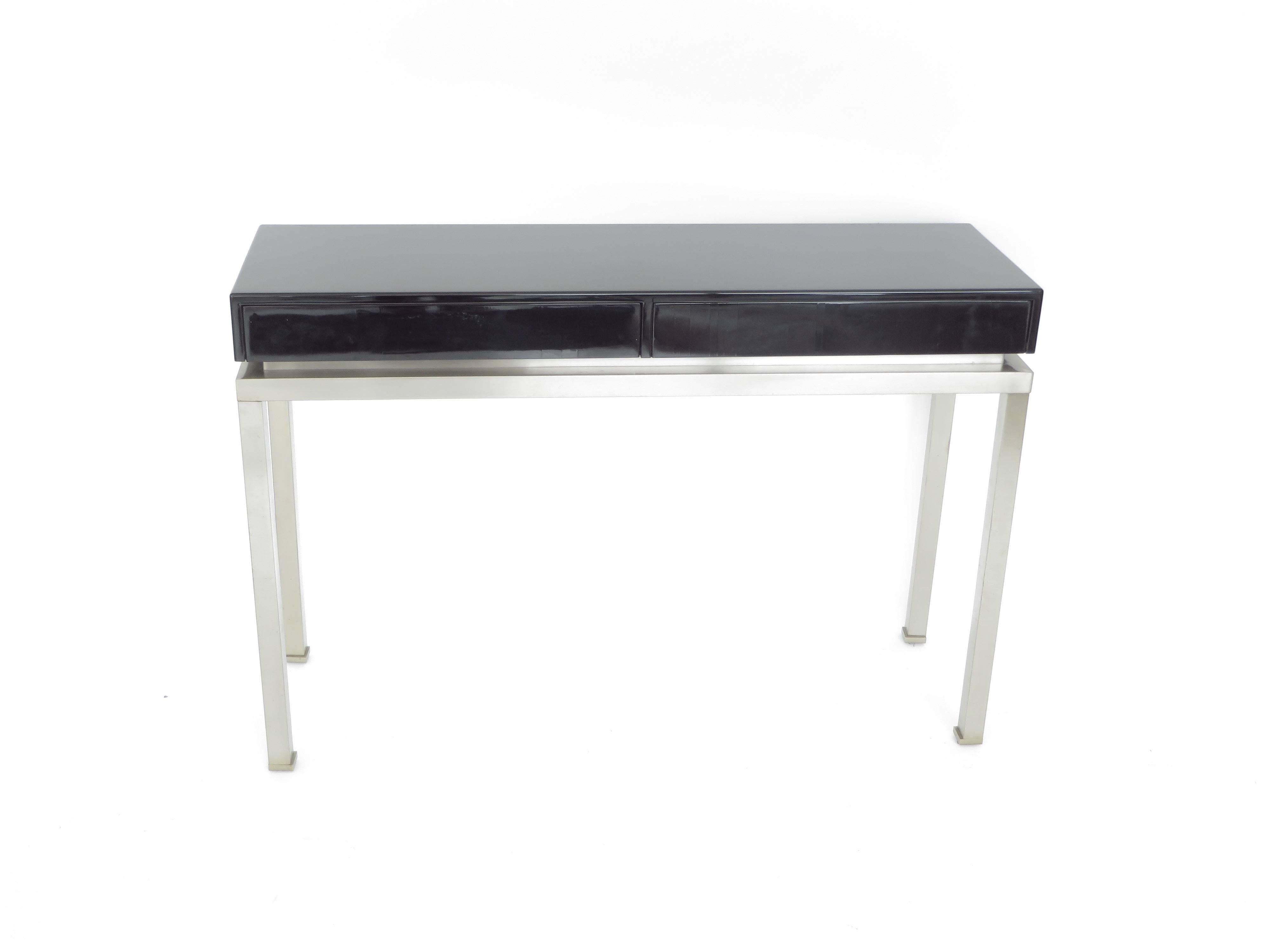 Beautiful large console by Guy Lefevre for Maison Jansen, 1970 period.
The top in black lacquered wood has two drawers and the base is made of brushed stainless steel with feet typical of Guy Lefevre in the Minimalist oriental manner.