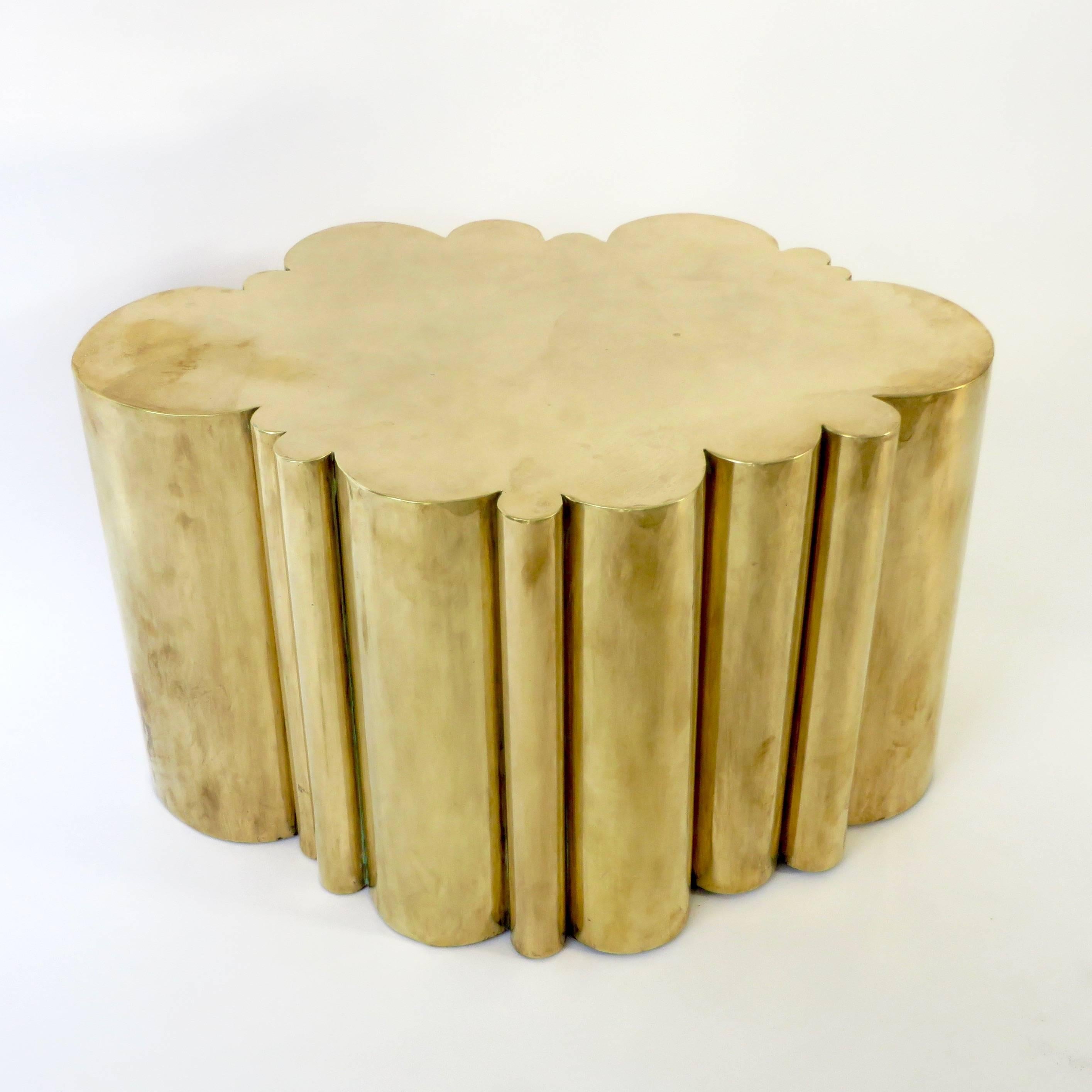 An organic formed brass cloud side or small coffee table that is folded and formed in to the form of a cloud attributed to Kam Tin.
Unsigned. 
Folded, solid brass sheet with steel base. 
Patina as shown in photos from age and use on the all the