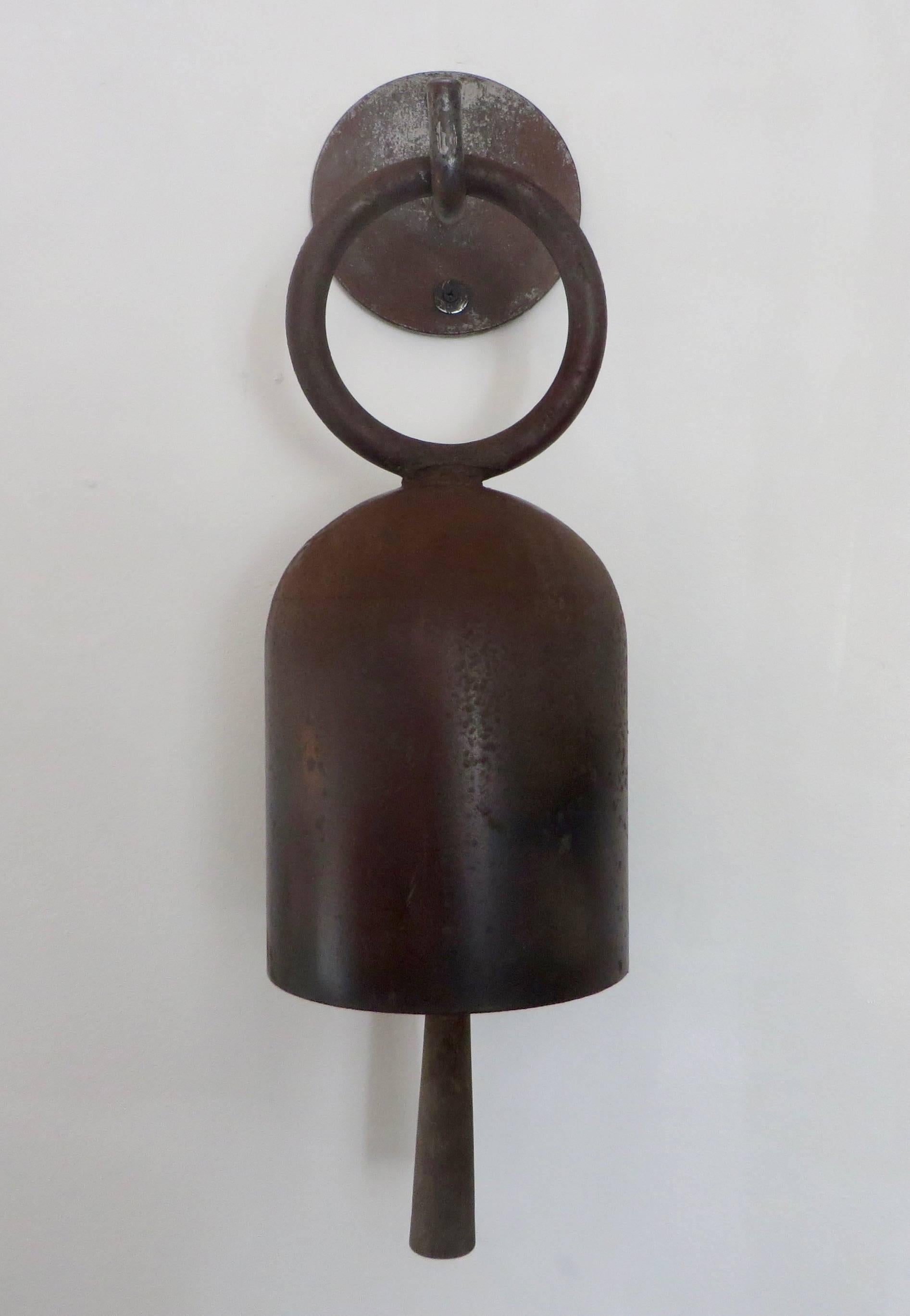 Pacific Northcoast artist Tom Torrens vintage Minimalist bronze door gong or door bell. 
The welded steel bell has a beautiful warm patina and the bell knocker is hand-carved wood with suede wrapper to create a soft gong. 
Each piece created by