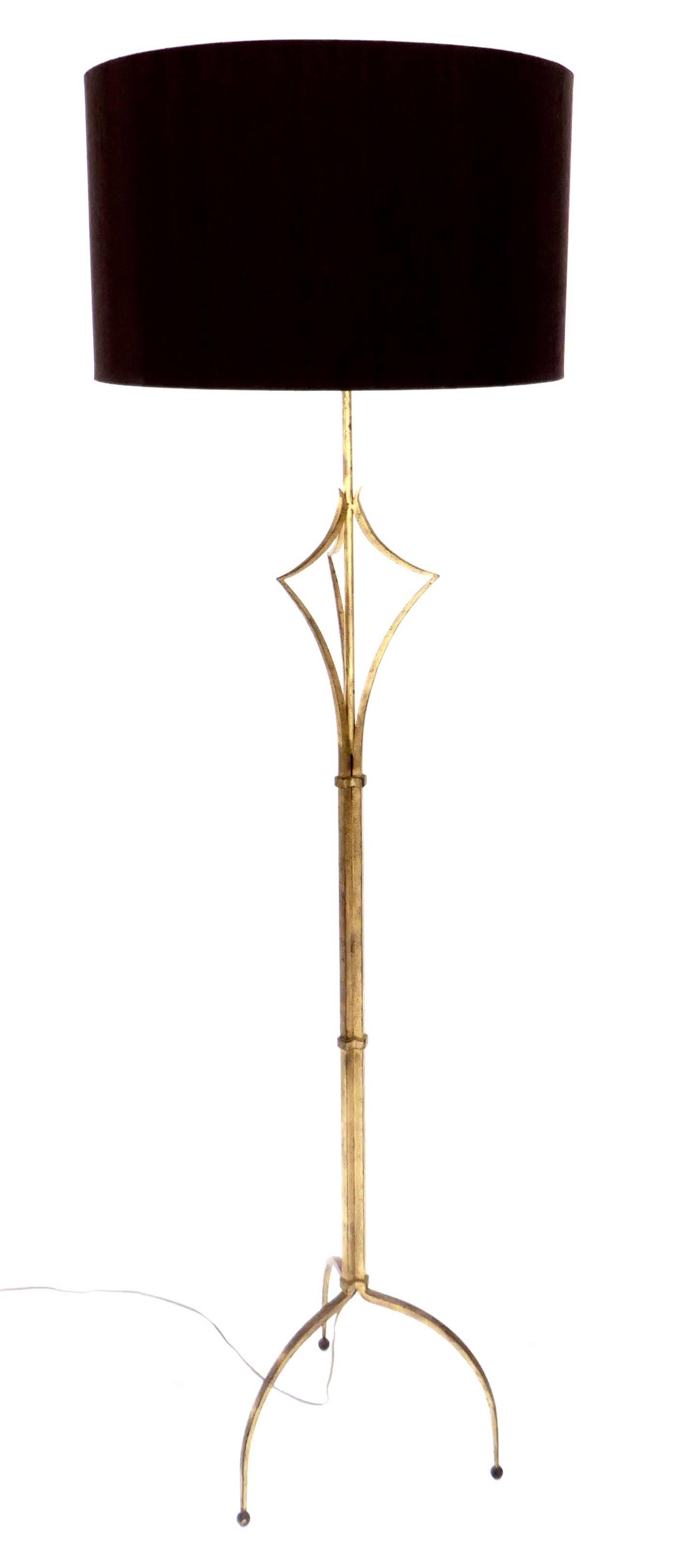 A French gilded iron floor lamp in the manner of Felix Agostini or Roger Thibier. 
Unsigned and undocumented but with wonderful delicate and exuberant details. 
Overall size: 13" x 13" x 13" x 58" to the bottom of the