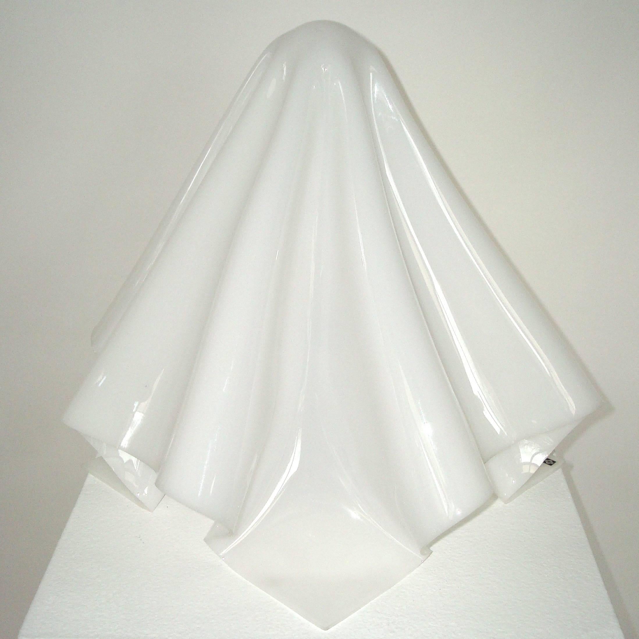 Shiro Kuramata K series table lamp or ghost lamp or OBA-Q lamp
The shade of molded sheet of acrylic is like a covering of soft, white cloth.
The light flowing throughout the shade casts a soft glow.
The shades are handmade, piece by piece, giving