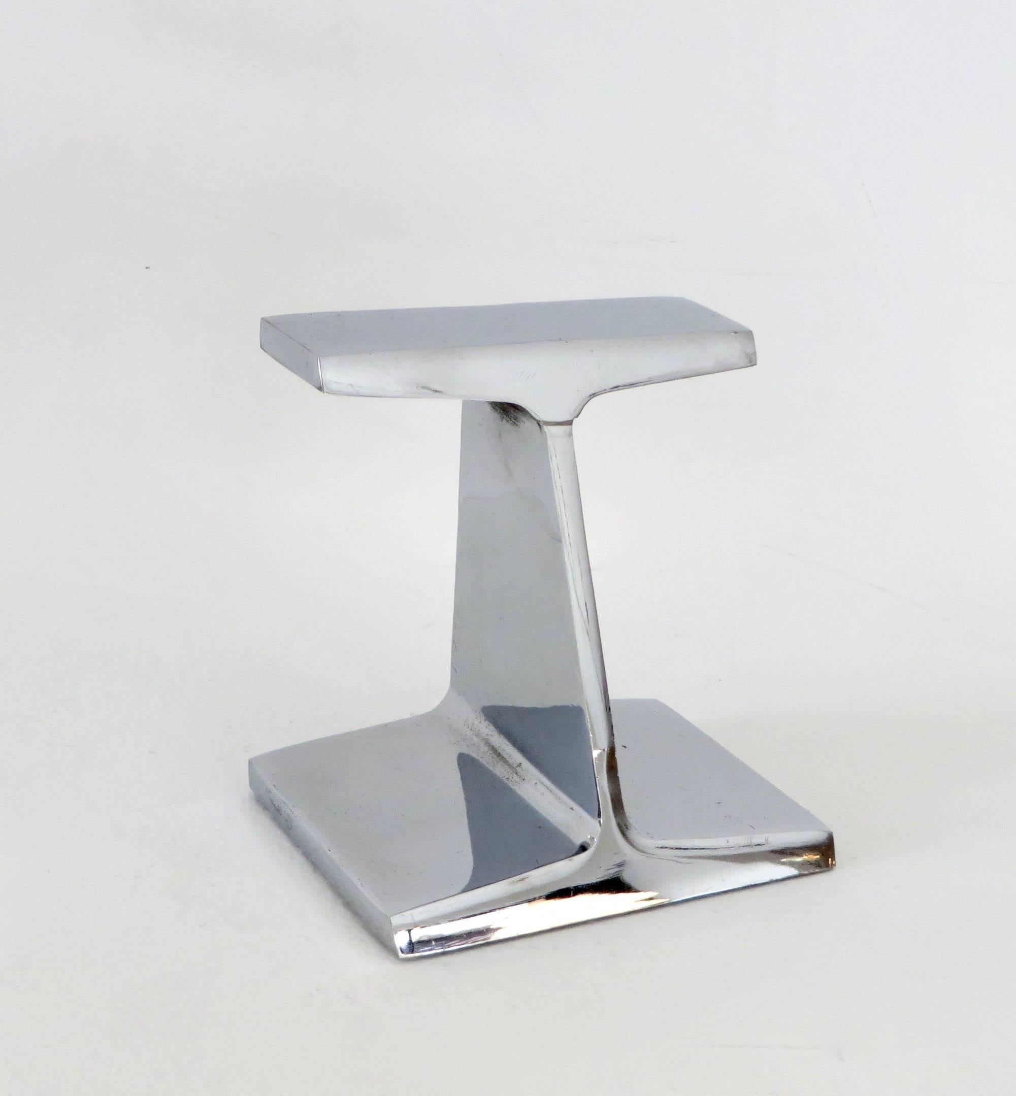 A charmed steel I beam bookend or paperweight by Kauser steel to commemorate the 25th anniversary chrome I beam bookend 1967.