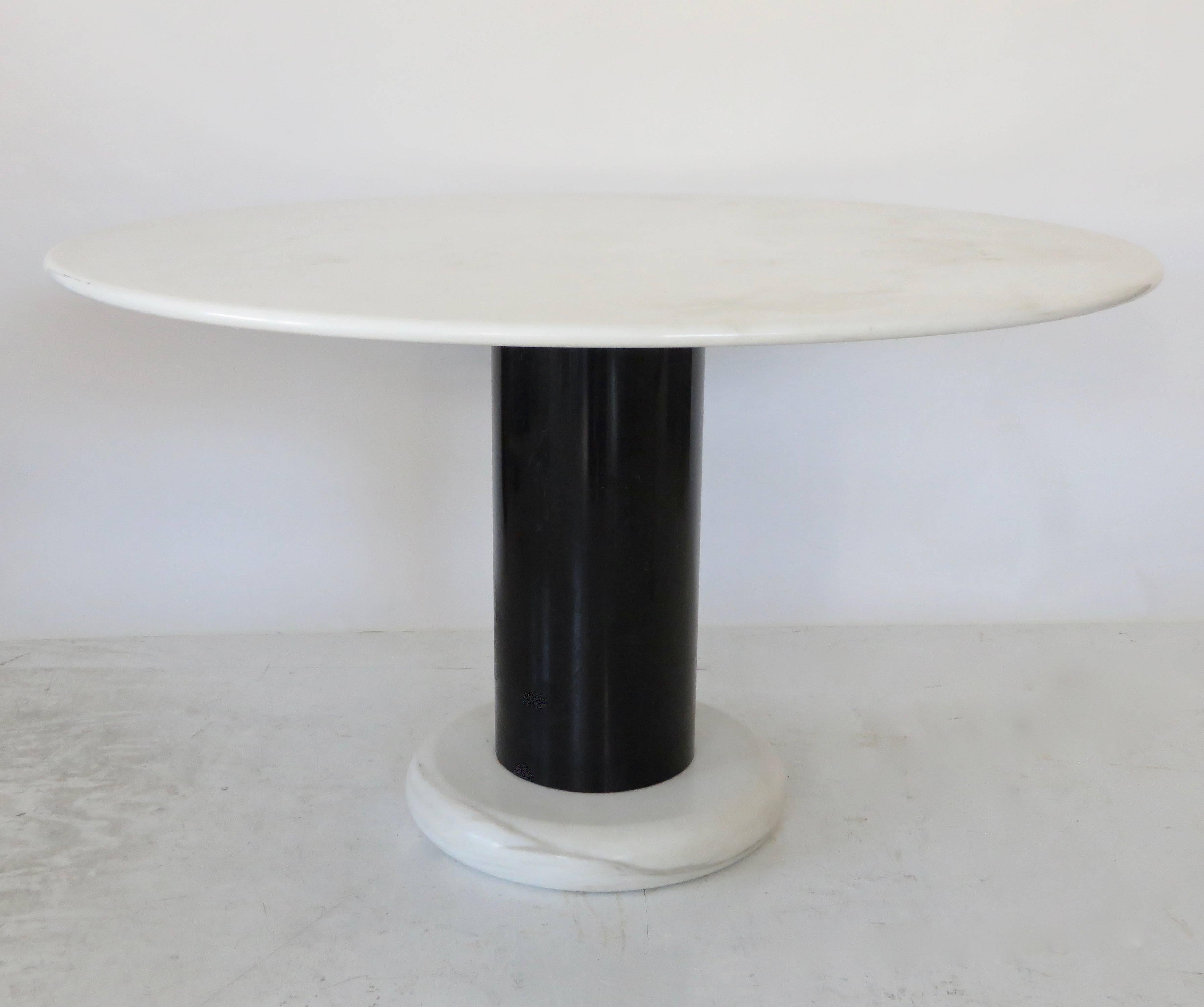 This very rare dining table Lotorosso is designed by Ettore Sottsass for Poltronova in Italy in 1965. The round top and the thick round foot are made of high quality Carrara marble. The cylindrical base is made of black lacquered metal. This model