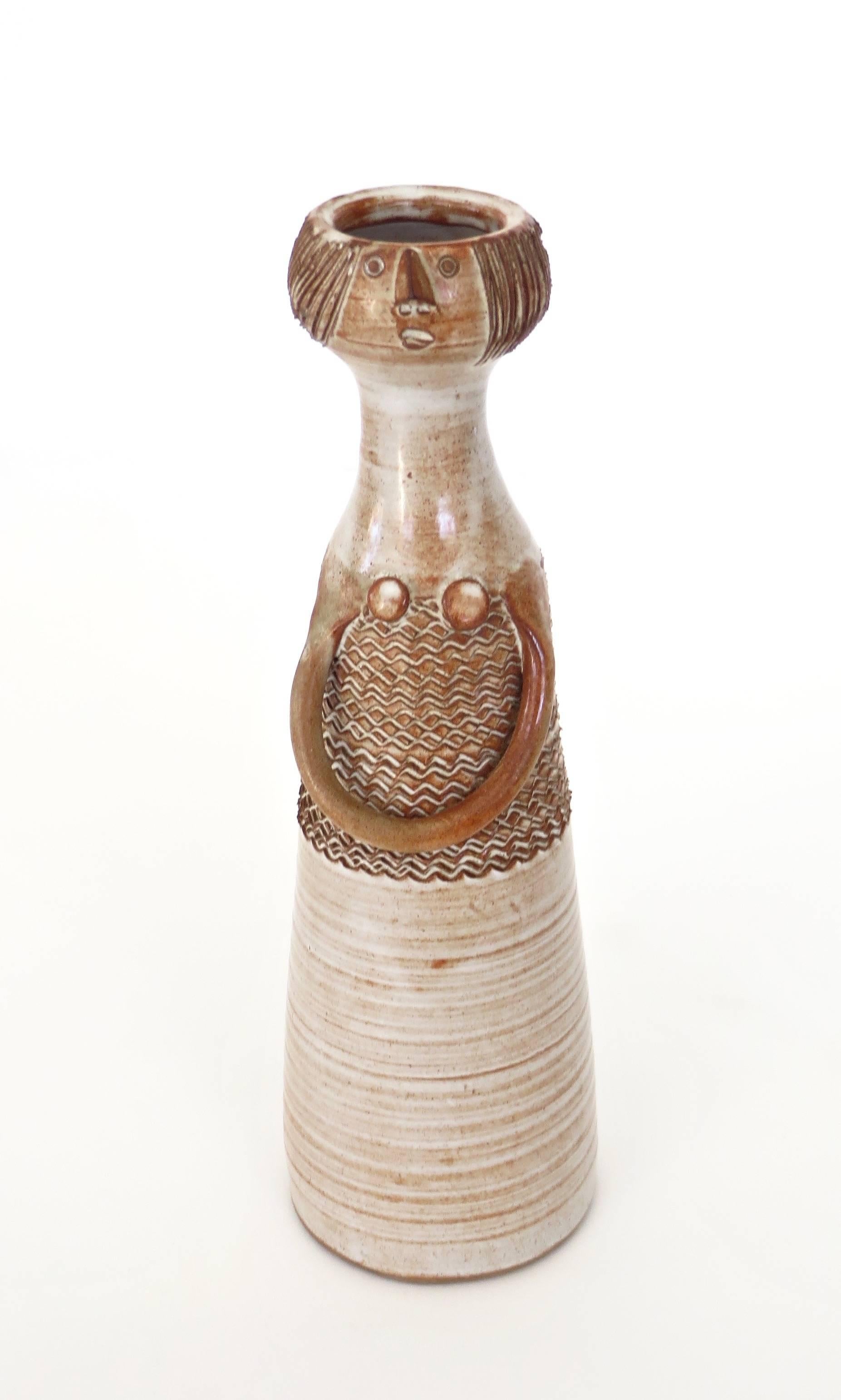 Ceramic vase in the form of a woman by the noted French ceramicist Jacques Pouchain. Signed both JP and Atelier Dieulefit. 
No chips or restorations, the glaze is perfect and the drawing of the scrafitto expressively executed. 
Born in 1925