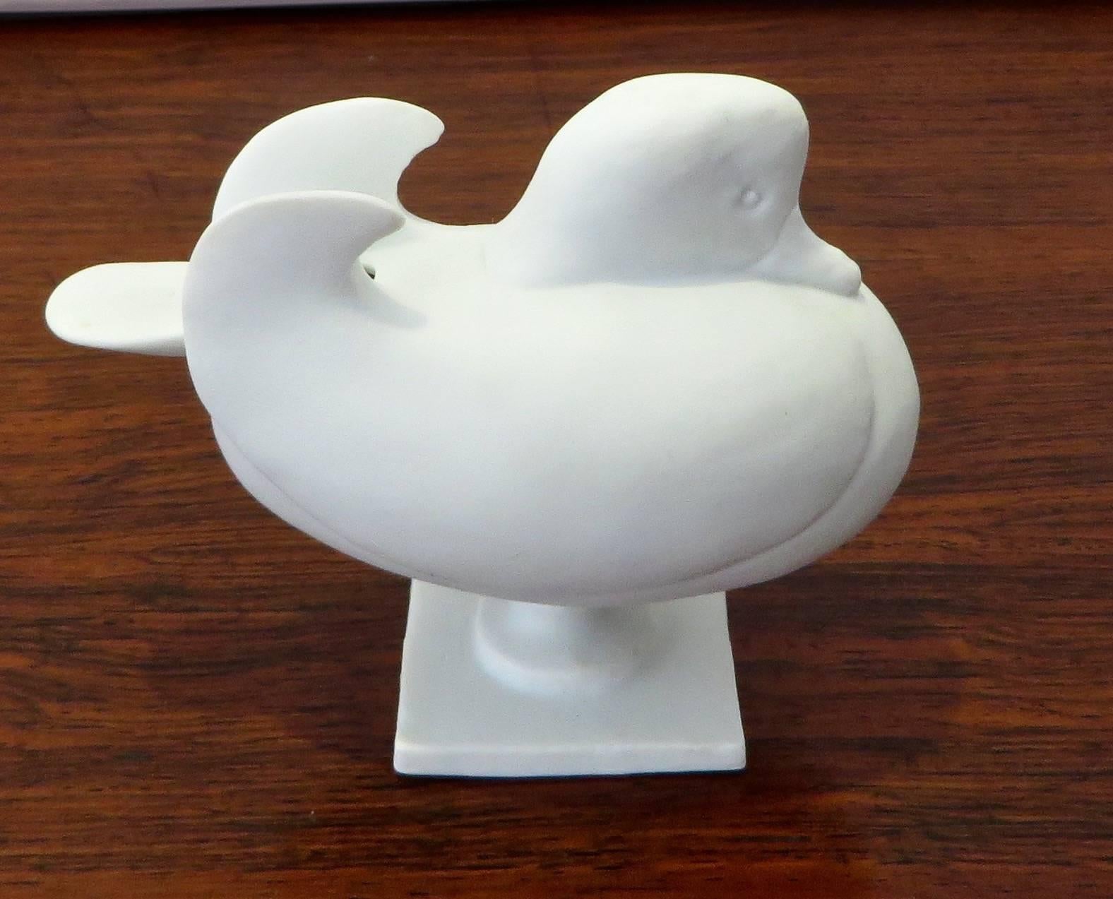 A pair of French Porcelain Salt Cellars by Francois-Xavier Lalanne designed for Porcelain de Sevres, Paris. 
Done as ducks, the tail is the spoon and removes to reveal the receptacle for the salt. 
Two available, one whose head faces forward, the